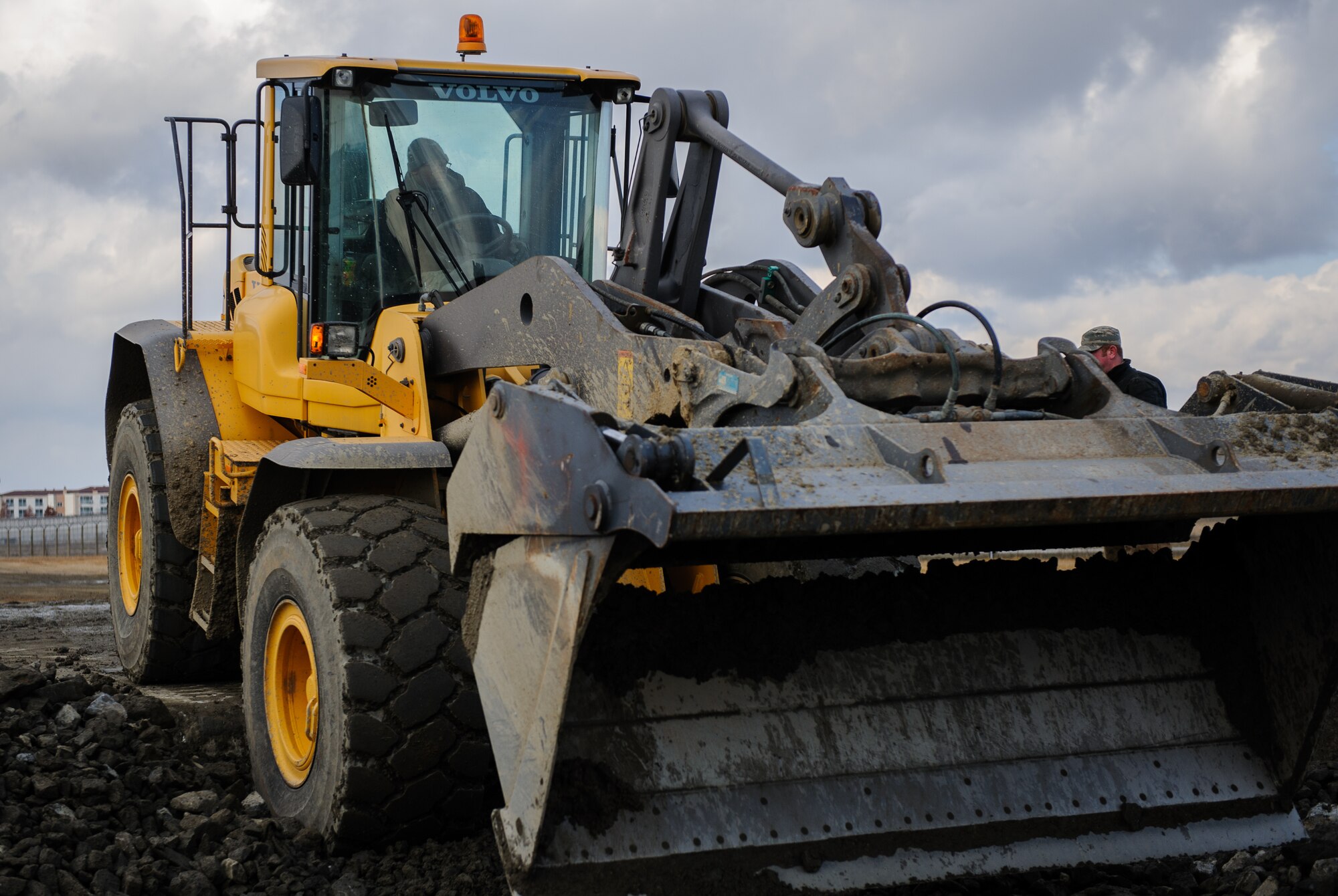Senior Airman Michael Todd, 8th Civil Engineer Squadron, flattens the rocks during an Airfield Damage Repair exercise at Kunsan Air Base, Republic of Korea, Dec. 19, 2013. Members from Detachment 1 554 RED HORSE came to Kunsan to train and develop civil engineer Airmen during the week long Silver Flag exercise. (U.S. Air Force photo by Senior Airman Armando A. Schwier-Morales/Released)