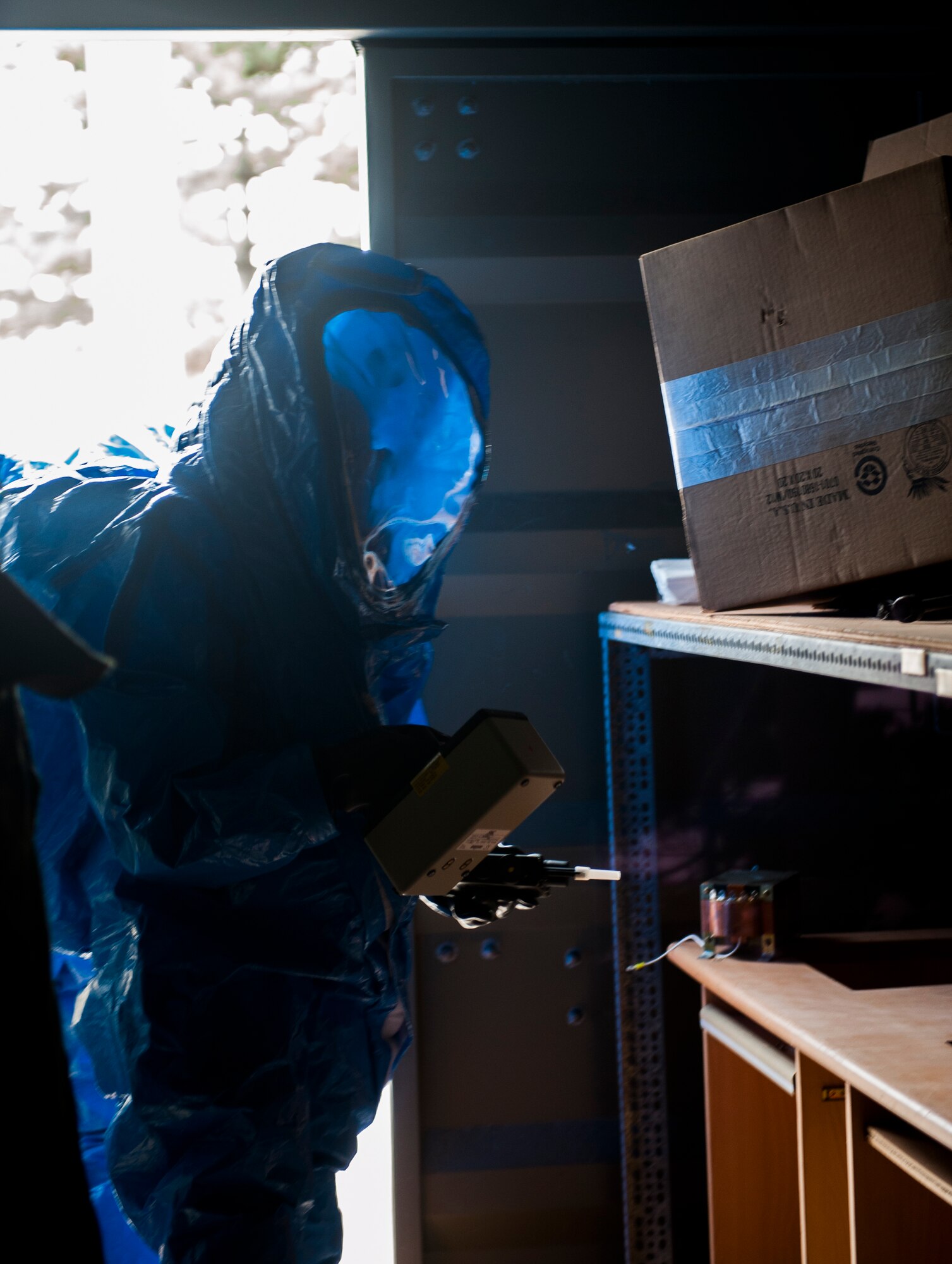 An Airman from the 8th Civil Engineer Squadron emergency management flight surveys a storage container during Exercise Silver Flag at Kunsan Air Base, Republic of Korea, Dec. 19, 2013. Members from Detachment 1 554 RED HORSE came to Kunsan to train and develop civil engineer Airmen during the week long Silver Flag exercise. (U.S. Air Force photo by Senior Airman Clayton Lenhardt/Released)