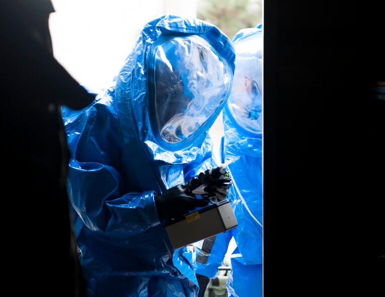 An Airman from the 8th Civil Engineer Squadron emergency management flight surveys a storage container during Exercise Silver Flag at Kunsan Air Base, Republic of Korea, Dec. 19, 2013. Members from Detachment 1 554 RED HORSE came to Kunsan to train and develop civil engineer Airmen during the week long Silver Flag exercise. (U.S. Air Force photo by Senior Airman Clayton Lenhardt/Released)
