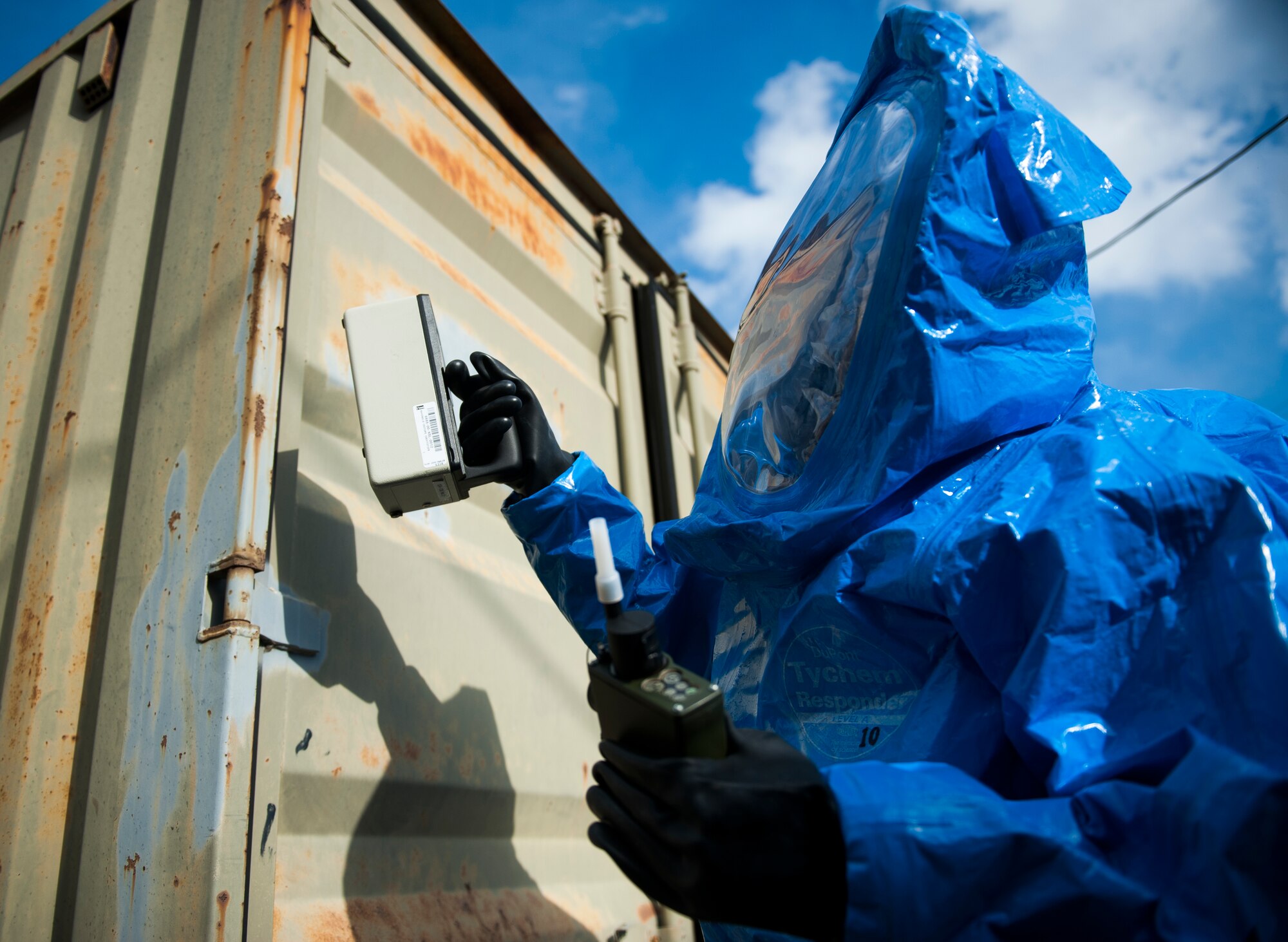 An 8th Civil Engineer Squadron emergency management flight Airman takes readings from a storage container during Exercise Silver Flag at Kunsan Air Base, Republic of Korea, Dec. 19, 2013. Members from Detachment 1 554 RED HORSE came to Kunsan to train and develop civil engineer Airmen during the week long Silver Flag exercise. (U.S. Air Force photo by Senior Airman Clayton Lenhardt/Released)