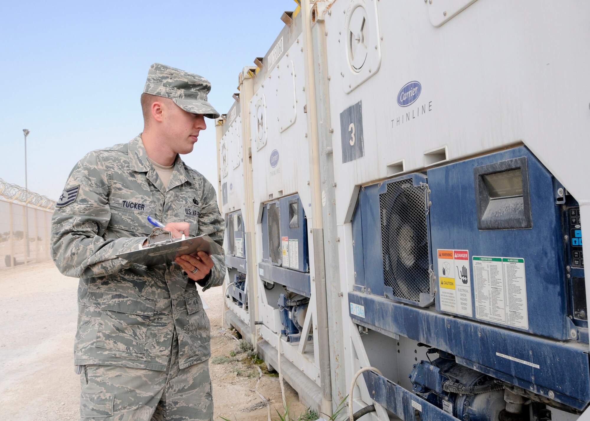 Staff Sgt. Jesse Tucker checks the temperature of a connex freezer at the 379th Air Expeditionary Wing in Southwest Asia, Dec. 17, 2013. The connex freezer is used to keep food products at the appropriate temperature so it doesn’t spoil. Tucker is a 379th Expeditionary Force Support Squadron member deployed from Hurlburt Field, Fla., and a Navarre, Fla., native. (U.S. Air Force photo/Senior Airman Hannah Landeros)