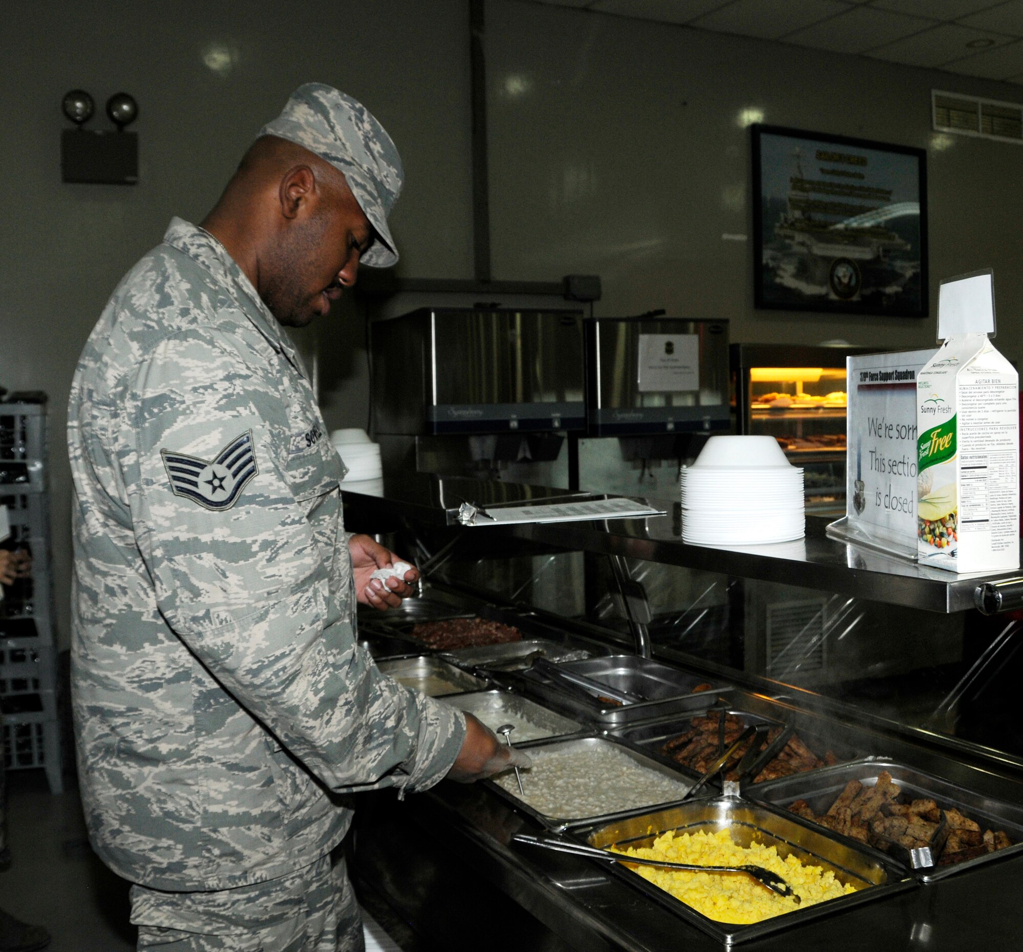 Staff Sgt. Justin Sowell checks the temperature of oatmeal during breakfast at the 379th Air Expeditionary Wing in Southwest Asia, Dec. 17, 2013. Sowell is a 379th Expeditionary Force Support Squadron member deployed from Barksdale Air Force Base, La., and a Detroit, Mich., native. (U.S. Air Force photo/Senior Airman Hannah Landeros)