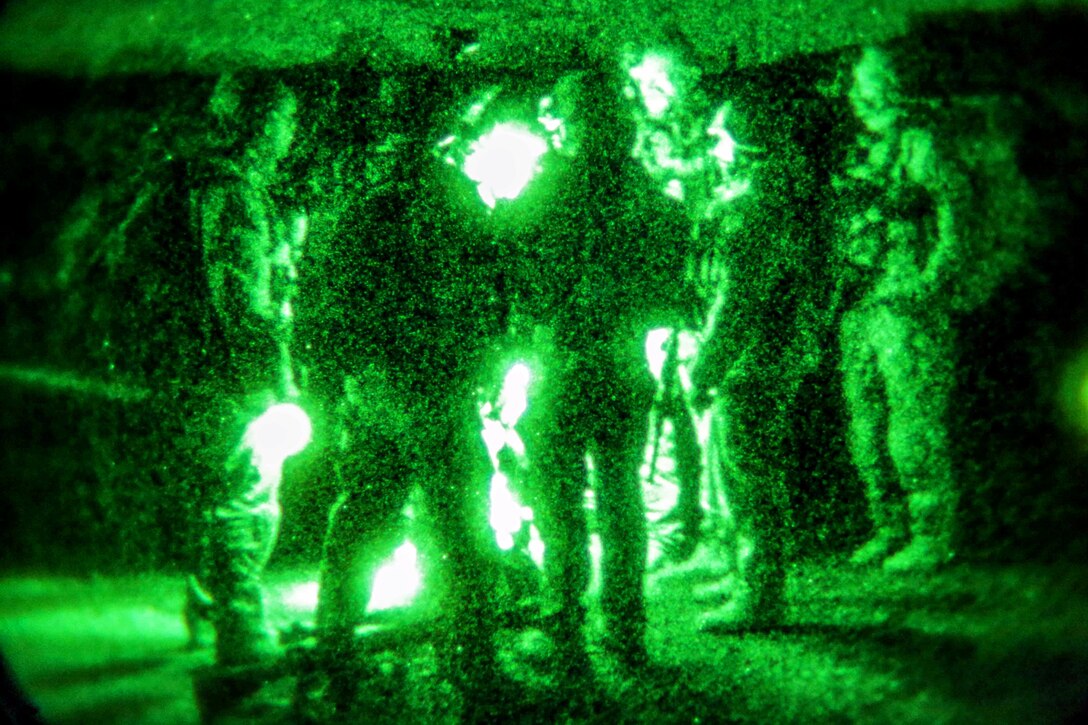 As seen through a night-vision device, U.S. Special Forces and Afghan national security forces conduct a pre-mission brief before a clearance operation in the Gaza valley of the Arghandab district in Afghanistan’s Zabul province, Dec. 11, 2013. The clearance operation was conducted to disrupt insurgent freedom of movement in the area.