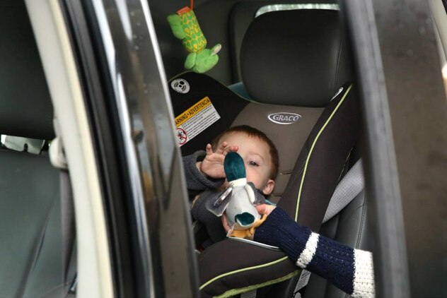 Ben receives a stuffed animal duck during the Armed Services YMCA's Secret Santa Event Dec. 19. Ben is the 19-month-old son of Petty Officer 3rd Class Brice and Victoria Courtnage. 