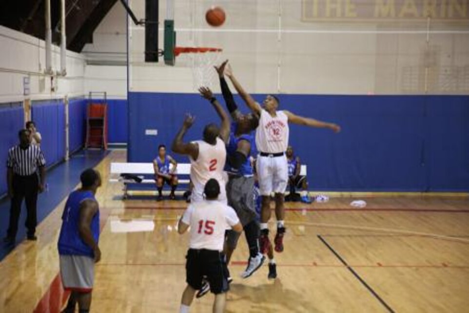 Members of the Day Walkers and the Rams battle for the rebound during the intramural basketball league championship game Dec. 9 at the Marine Dome on Marine Corps Air Station Cherry Point. The Day Walkers beat the Rams 56-52.