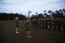 Navy Capt. Michael Sokolowski (left), the commanding officer of 2nd Medical Battalion, Combat Logistics Regiment 25, 2nd Marine Logistics Group, and Sgt. Joel Contreras (right), addresses service members with the battalion prior to a reindeer run aboard Camp Lejeune, N.C., Dec. 20, 2013. The run was meant to build camaraderie and allow service members to have fun while working out. (U.S. Marine Corps photo by Lance Cpl. Shawn Valosin)