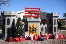 Marines with 8th Engineer Support Battalion, 2nd Marine Logistics Group embrace the generous spirit of Christmas, lending a hand to their fellow service members.  Lt. Col. Ferdinand F. Llantero, the commanding officer of 8th ESB, presented an assortment of Christmas gifts to selected service members in front of the 8th ESB castle, here, Dec. 19. Service members with children were selected by their peers and chain of command to receive the gifts, which they can give to their children on Christmas.