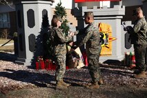 Marines with 8th Engineer Support Battalion, 2nd Marine Logistics Group embrace the generous spirit of Christmas, lending a hand to their fellow service members.  Lt. Col. Ferdinand F. Llantero, the commanding officer of 8th ESB, presented an assortment of Christmas gifts to selected service members in front of the 8th ESB castle, here, Dec. 19. Service members with children were selected by their peers and chain of command to receive the gifts, which they can give to their children on Christmas.