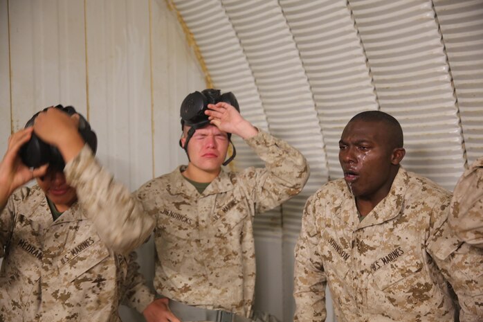 Marines of Company A, 1st Recruit Training Battalion, feel the effects of the CS gas in the Confidence Chamber at Edson Range aboard Marine Corps Base Camp Pendleton, Dec. 9. Marines’ faces were exposed to the gas twice to build their confidence.