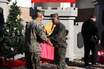Marines with 8th Engineer Support Battalion, 2nd Marine Logistics Group embrace the generous spirit of Christmas, lending a hand to their fellow service members.  Lt. Col. Ferdinand F. Llantero, the commanding officer of 8th ESB, presented an assortment of Christmas gifts to selected service members in front of the 8th ESB castle, here, Dec. 19. Service members with children were selected by their peers and chain of command to receive the gifts, which they can give to their children on Christmas.