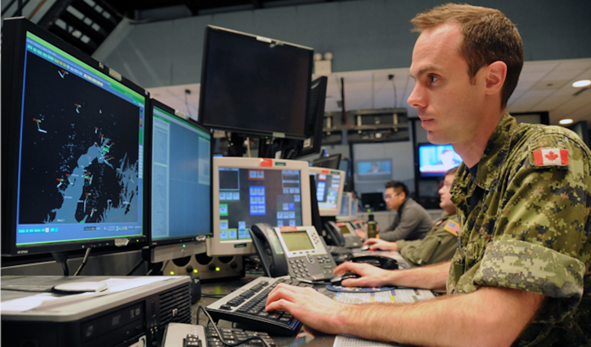 Royal Canadian air force Capt. Dave Gosselin tracks aircraft in Alaska air space ensuring air sovereignty in the Alaskan NORAD Region Regional Air Operations Center. U.S. and Canadian service members utilize 15 radar stations to monitor Santa as he traverses the airspace around the northern latitudes of North America, a mission ANR has successfully accomplished for 50 years. (U.S. Air Force photo/Tech. Sgt. John Gordinier)