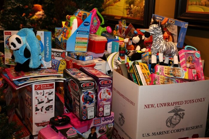 Marines, sailors and spouses from the Combat Center, Marine Corps Base Camp Pendleton and Marine Corps Air Station Miramar joined Professional Golfers’ Association West club members for dinner at the PGA West clubhouse in La Quinta, Calif., Dec. 14, 2013. The dinner is an annual event in which the club members invite service members over for a free dinner and a low-cost, weekend stay at their resort in honor of the Toys for Tots program.