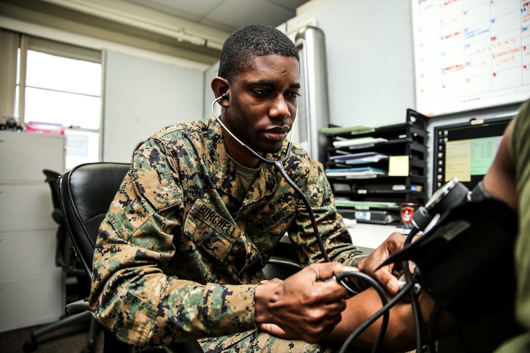 Petty Officer 3rd Class Rylan Burchell, hospital corpsman, 15th Marine Expeditionary Unit, conducts a check up on a patient aboard Camp Pendleton, Calif., Dec. 19. Burchell is studying for the Enlisted Fleet Marine Force Specialist exam and preparing for his qualification board. Burchell, 25, is from Kingston, Jamaica. (U.S. Marine Corps photo by Cpl. Emmanuel Ramos)