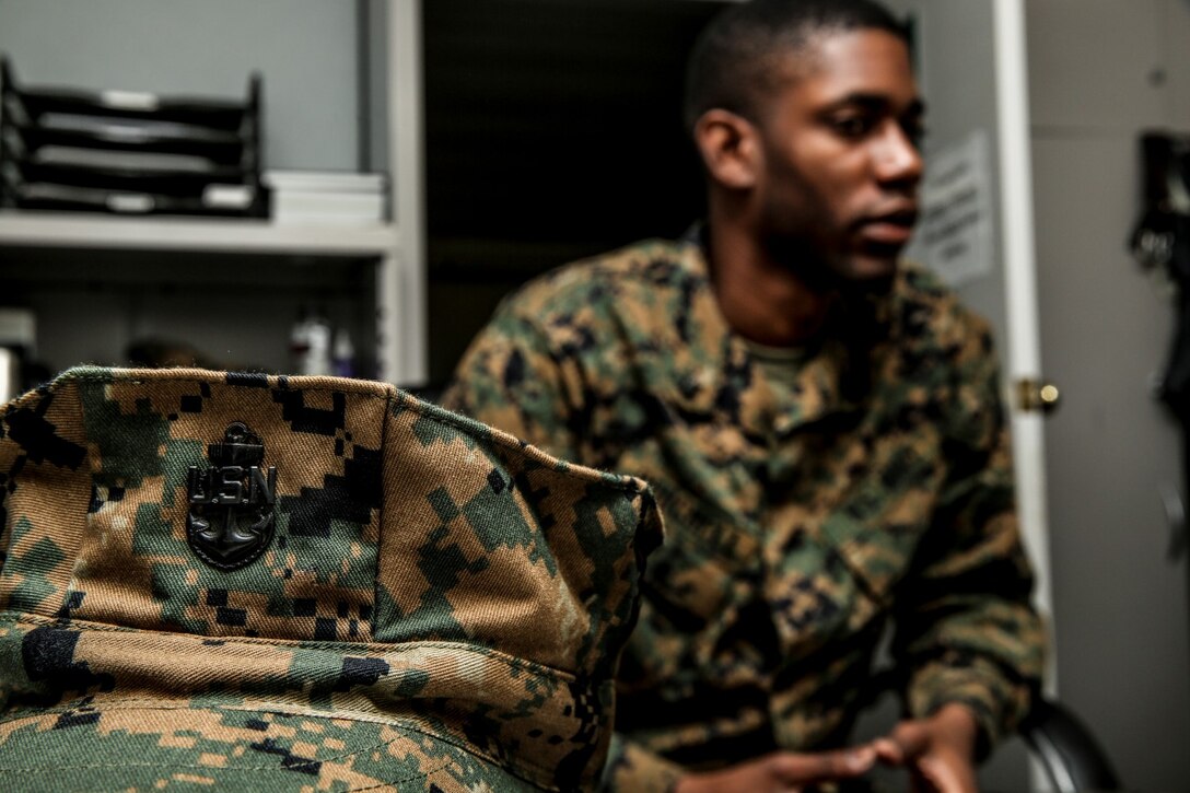 Petty Officer 3rd Class Rylan Burchell, hospital corpsman, talks to Chief Petty Officer Emmanuel Essenete, medical chief, both with the 15th Marine Expeditionary Unit, about career progression aboard Camp Pendleton, Calif., Dec. 19. Burchell is studying for the Enlisted Fleet Marine Force Specialist exam and preparing for his qualification board. Burchell, 25, is from Kingston, Jamaica. (U.S. Marine Corps photo by Cpl. Emmanuel Ramos)