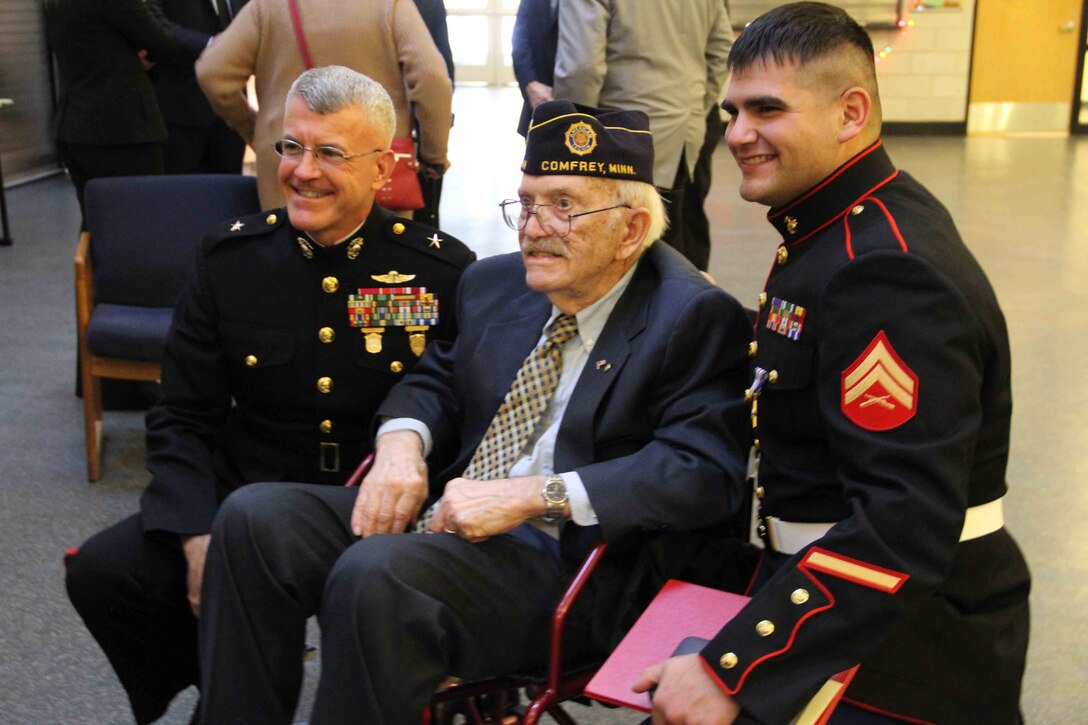 Cpl. Ethan Nagel, a Prior Lake, Minn. native, poses for a photo with his grandfather, retired Marine and Korean War veteran Richard Allen, and Brigadier General James S. Hartsell, commanding general of the 4th Marine Division, during Nagel's award ceremony after having recieved the Silver Star, Dec. 17.