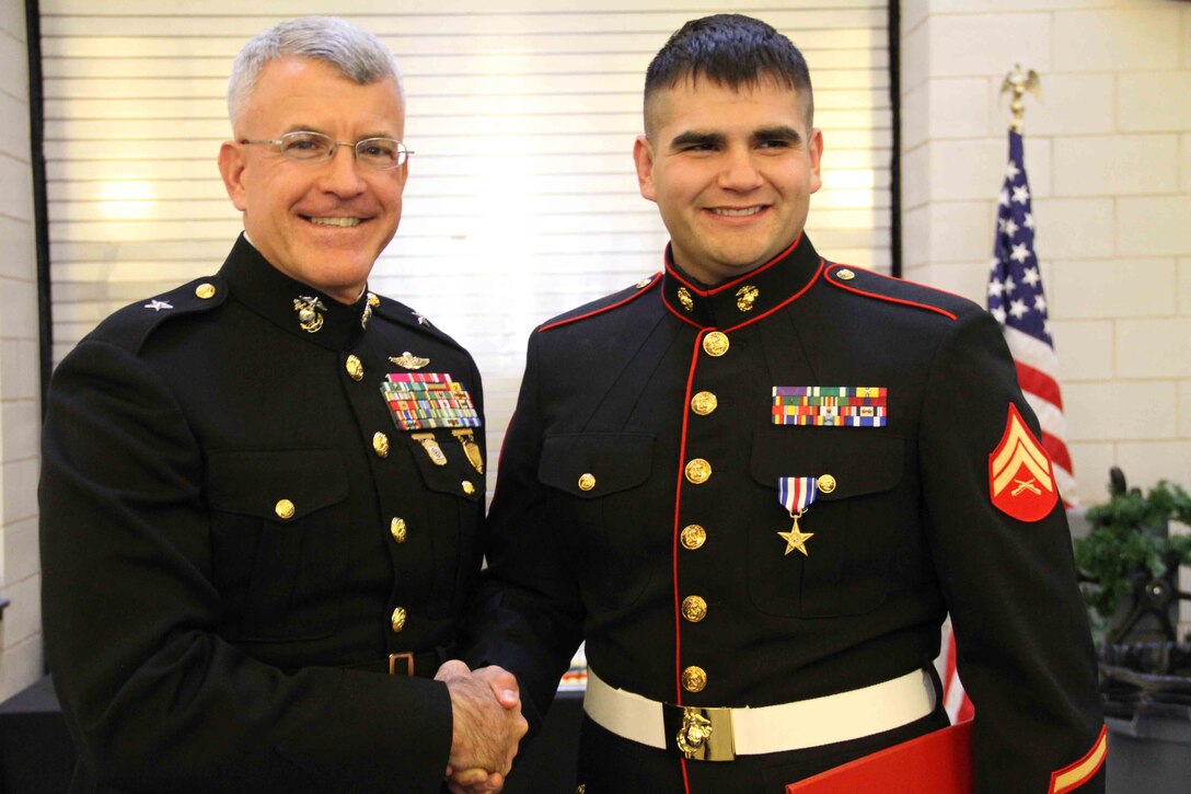 Cpl. Ethan Nagel, a Prior Lake, Minn. native, shakes hands with Brigadier General James S. Hartsell, commanding general of the 4th Marine Division, after having received the Silver Star, Dec. 17, for his actions in Afghanistan.