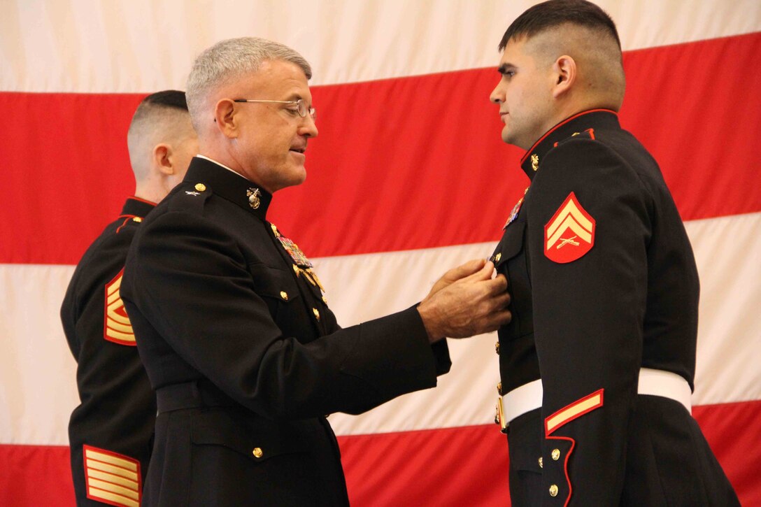 Cpl. Ethan Nagel, a Prior Lake, Minn. native, receives the Silver Star from Brigadier General James S. Hartsell, commanding general of the 4th Marine Division, Dec. 17, for his actions in Afghanistan.