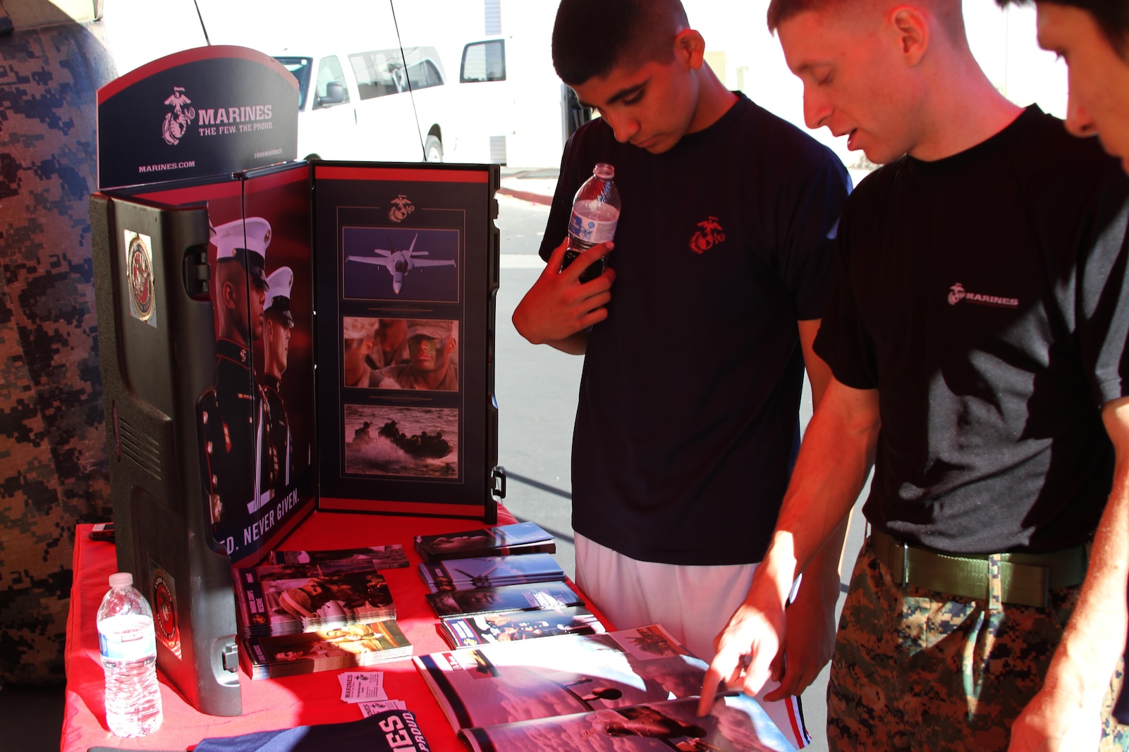 Sgt. Reed, a recruiter with Recruiting Sub Station Palm Desert, explains different Marine Corps enlistment programs during a Toys for Tots event in Palm Desert, Calif., Dec. 8, 2014.