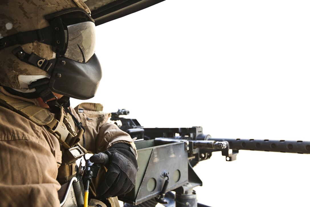 Staff Sgt. Jacob Murphy, a crew chief with Marine Light Attack Squadron 367, "Scarface," speaks with the pilots of the UH-1Y Huey, May 5. In addition to communicating with the pilots, Murphy mans the .50-caliber heavy machine gun on the helicopter.