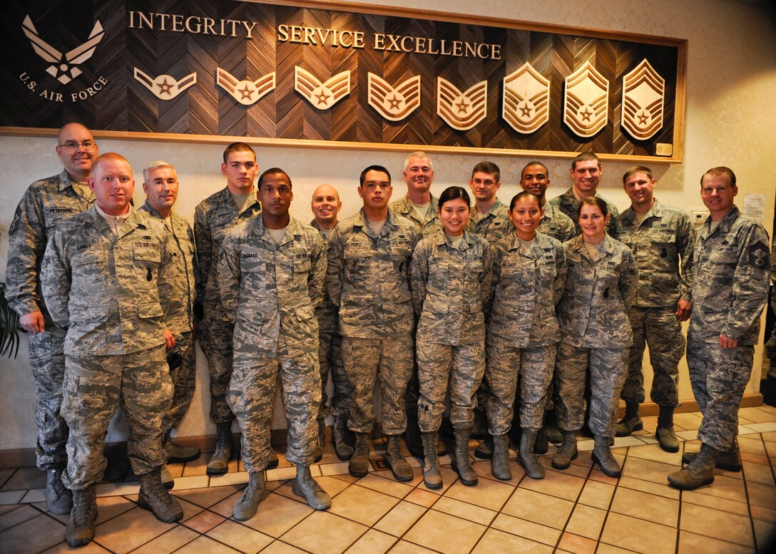 VANDENBERG AIR FORCE BASE, Calif. – Airmen of various ranks and units pose in front of the new enlisted rank display here Dec. 19, 2013. The display is located in the Pacific Coast Club hallway. (U.S. Air Force photo/ Airman 1st Class Yvonne Morales)