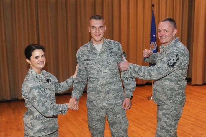 Now Tech. Sgt. Donovan Fredericksen, Explosive Ordnance Disposal craftsman, receives congratulations as Col. Kathryn Kolbe, 75th Air Base Wing commander, and Chief Master Sgt. Jason France, 75th ABW command chief, surprise him with a promotion under the Stripes for Exceptional Performance, or STEP, program on Dec. 18. STEP promotions are a means for commanders to promote deserving, hard-charging Airmen for compelling, although not quantifiable, reasons. (U.S. Air Force photo by Alex R. Lloyd)