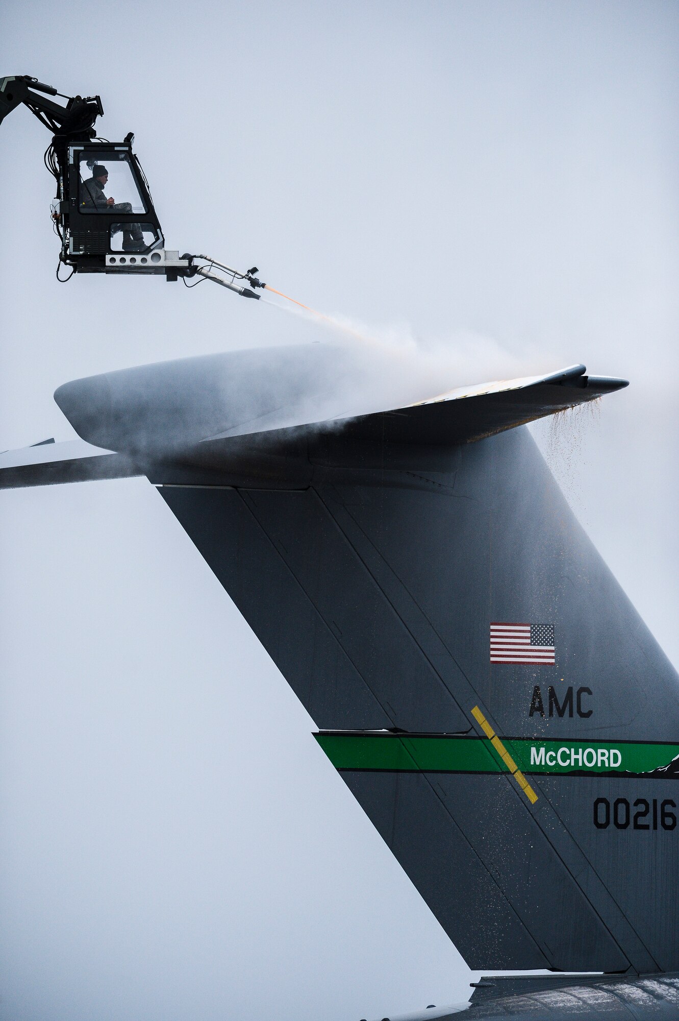 Staff Sgt. Mitchell Johnson, 62nd Aircraft Maintenance Squadron crew chief, sprays de-icing fluid onto the tail of a C-17 Globemaster III Dec. 20, 2013, following a snowstorm at Joint Base Lewis-McChord, Wash. The de-icing fluid removes and prevents further accumulation of snow and ice, which could severely affect the aircraft's ability to provide lift and maneuver safely if not treated. (U.S. Air Force photo/Tech. Sgt. Sean Tobin)