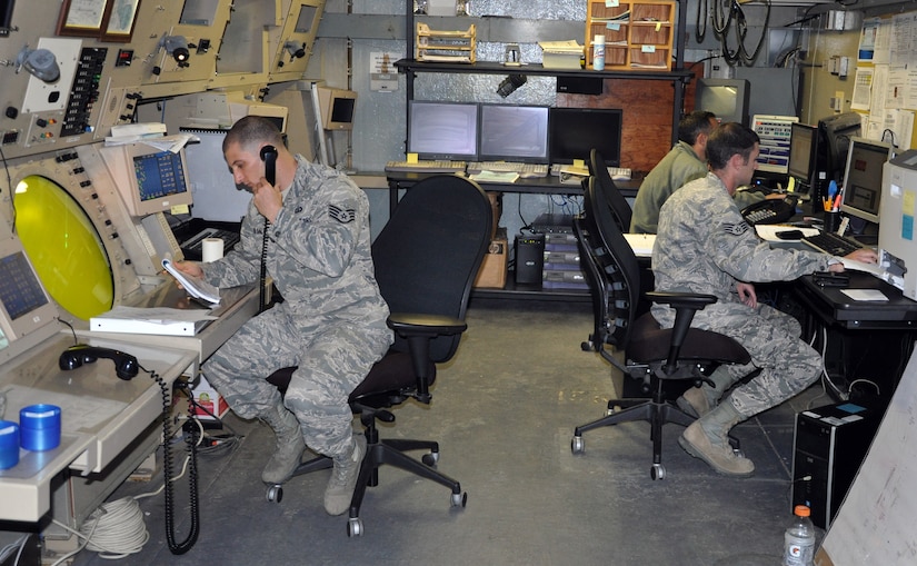 U.S. Air Force Air Traffic Controllers assigned to the 612th Air Base Squadron, Joint Task Force-Bravo, work at the Ground Control Approach (GCA) facility, Soto Cano Air Base, Honduras, Dec. 19, 2013. Airmen who work in the GCA facility are responsible for directing air traffic around the base, to include aircraft sequencing, issuing safety and traffic alerts, and maintaining aircraft separation. (U.S. Air Force photo by Capt. Zach Anderson)