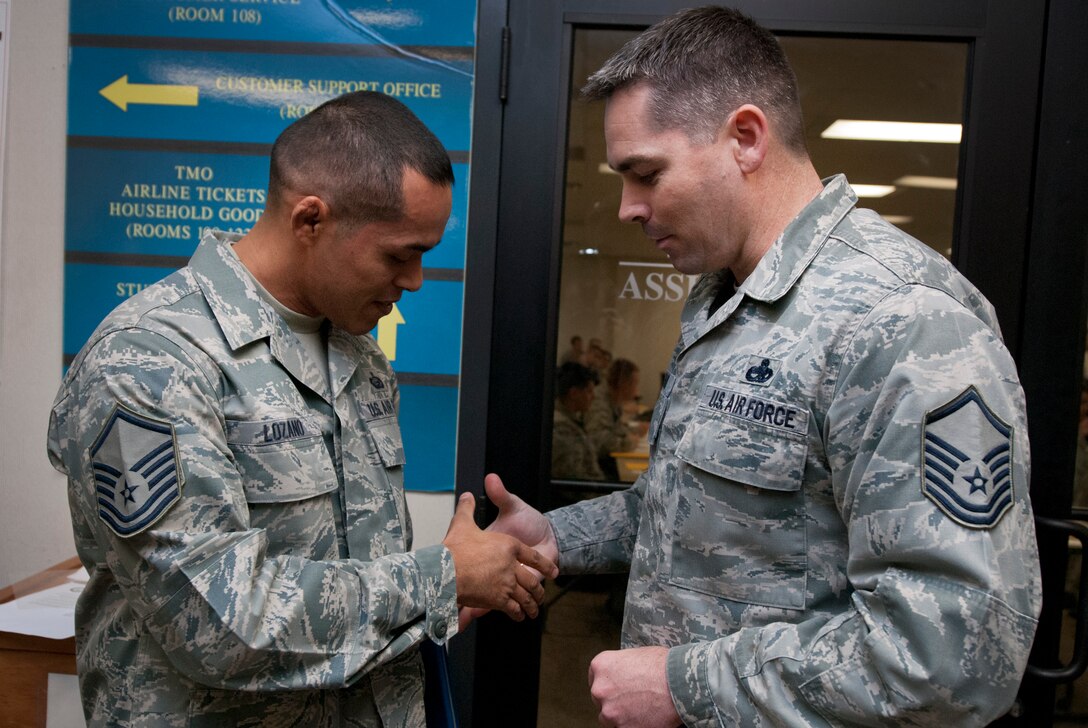 Tech. Sgt. Rolando Lozano, 82nd Force Support Squadron student relocations NCOIC, is welcomed to the senior NCO corps by Master Sgt. John Barr, during a Stripes for Exceptional Stripes promotion surprise visit to the 82nd Force Support Squadron Dec. 20, 2013. Lozano was STEP promoted to master sergeant for his leadership as the student relocations NCOIC. His wife, Master Sgt. Nadia Lozano, was STEP promoted in July 2013. (U.S. Air Force photo/Tech. Sgt. Mike Meares)