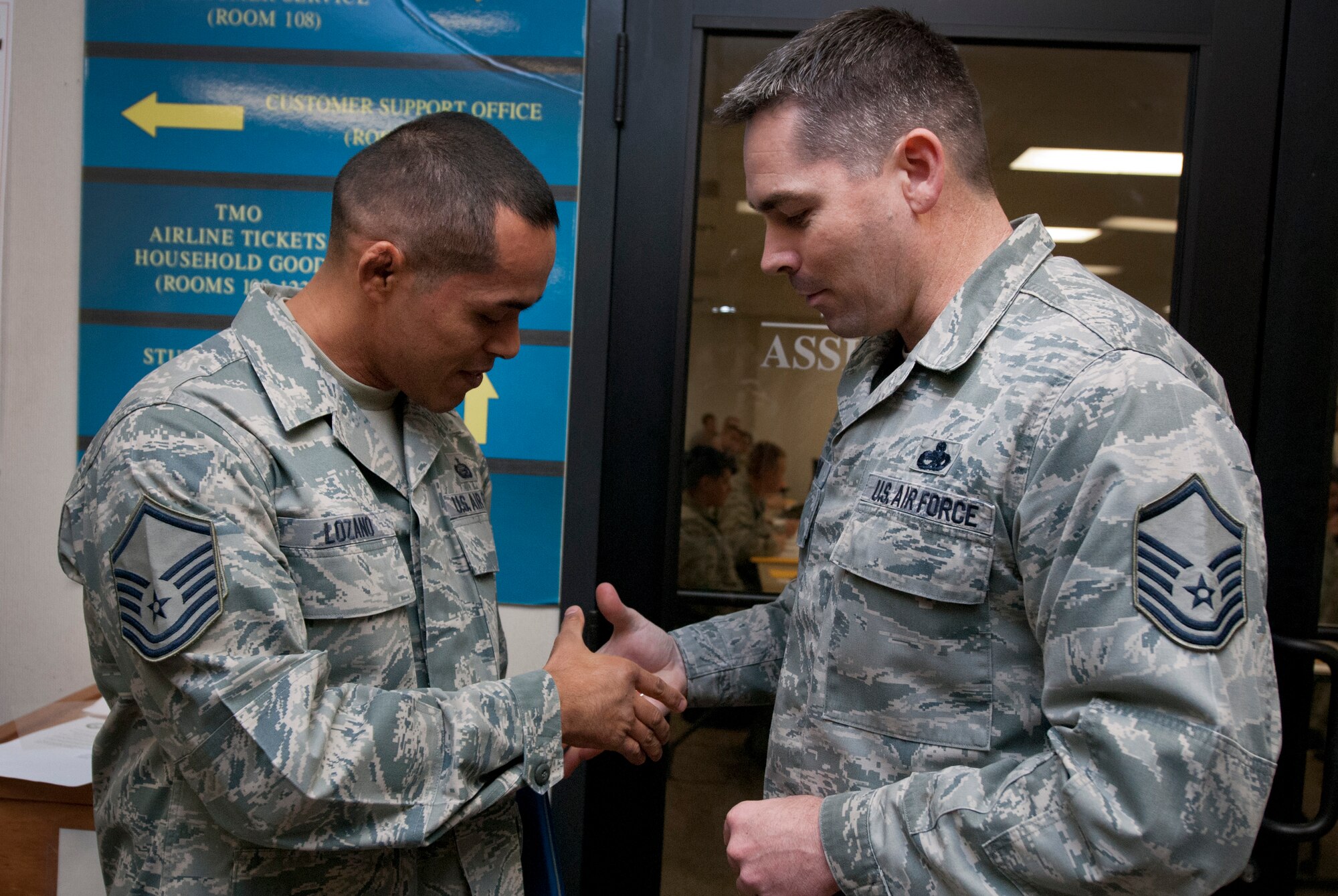 Tech. Sgt. Rolando Lozano, 82nd Force Support Squadron student relocations NCOIC, is welcomed to the senior NCO corps by Master Sgt. John Barr, during a Stripes for Exceptional Stripes promotion surprise visit to the 82nd Force Support Squadron Dec. 20, 2013. Lozano was STEP promoted to master sergeant for his leadership as the student relocations NCOIC. His wife, Master Sgt. Nadia Lozano, was STEP promoted in July 2013. (U.S. Air Force photo/Tech. Sgt. Mike Meares)