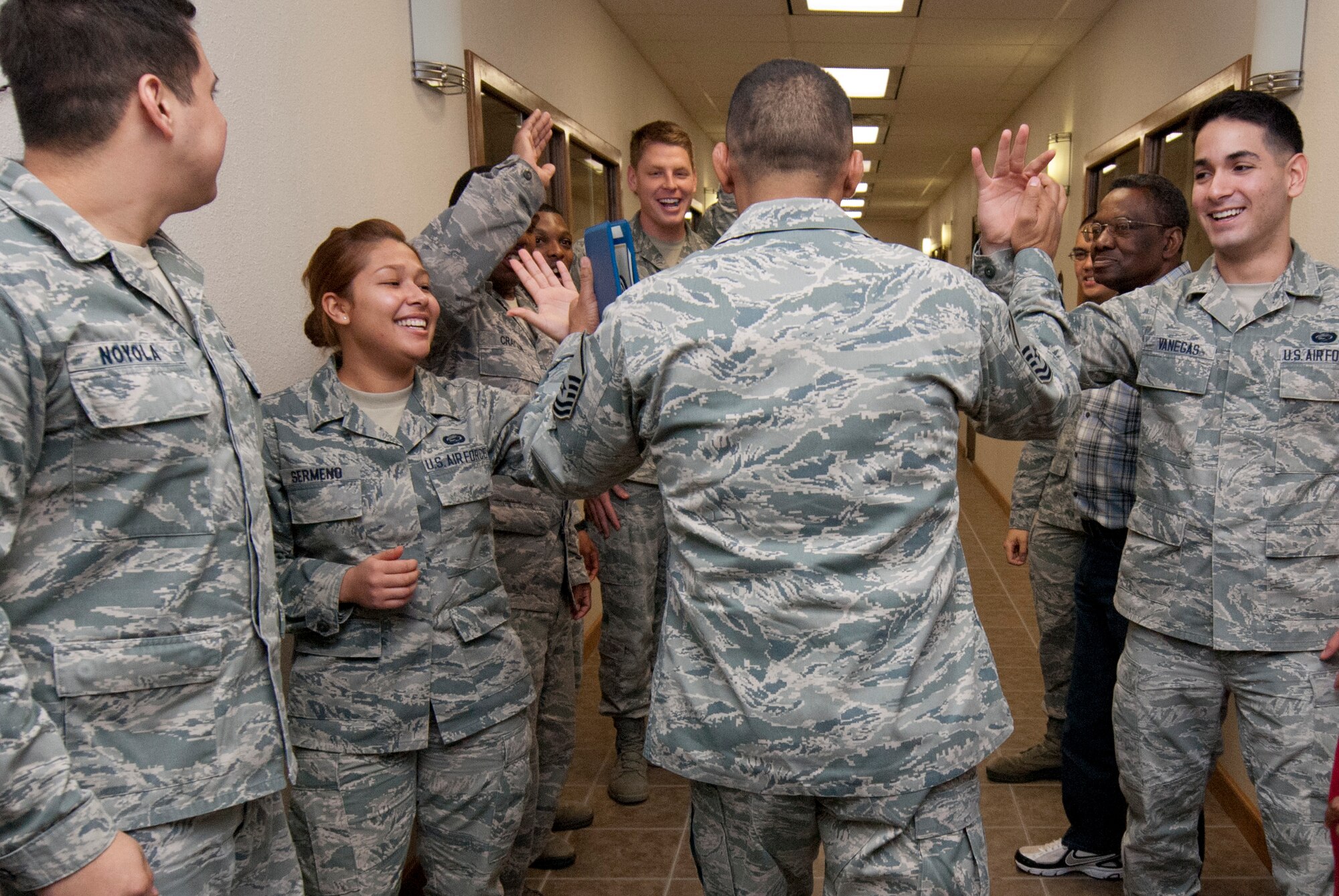 Master Sgt. Rolando Lozano, 82nd Force Support Squadron student relocations NCOIC, gives high fives to fellow Airmen after being STEP promoted by Brig. Gen. Scott Kindsvater, 82nd Training Wing commander, Dec. 20, 2013. Lozano was STEP promoted to master sergeant for his leadership as the 82nd Force Support Squadron student relocations NCOIC. His wife, Master Sgt. Nadia Lozano, was STEP promoted in July 2013. (U.S. Air Force photo/Tech. Sgt. Mike Meares)