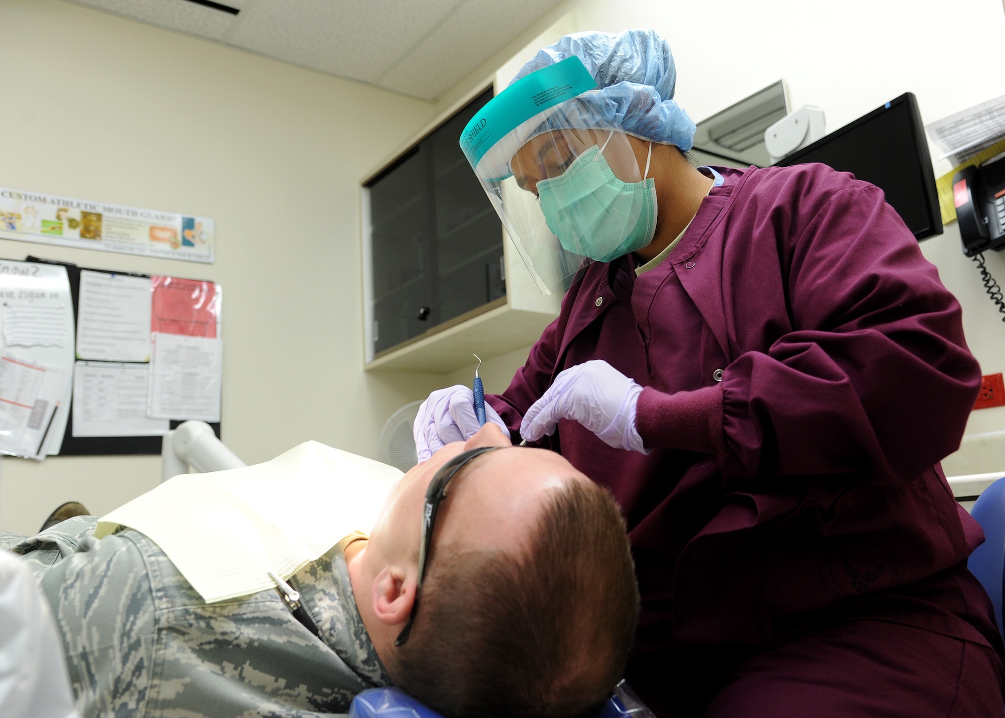 Staff Sgt. Shaleena Pulliam, 341st Medical Operations Squadron dental prophylaxis technician, finishes up a cleaning on a patient at the Malmstrom Dental Clinic on Dec. 4. According to Pulliam, “Dental health is very important. A lot of people don’t realize that dental health can affect your entire body.”  (U.S. Air Force photo/Senior Airman Cortney Paxton)