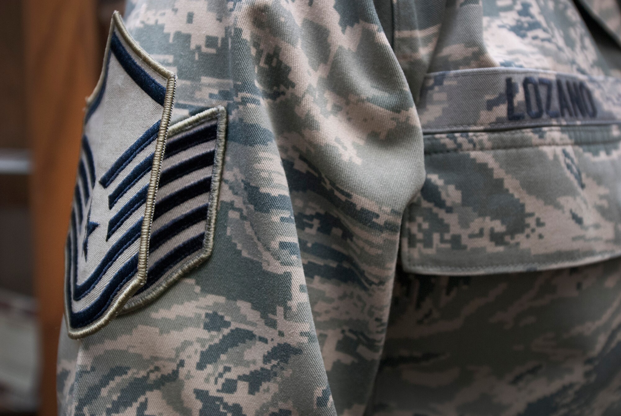 Brig. Gen. Scott Kindsvater, 82nd Training Wing commander, and Chief Master Sgt. Eric Johnson, pin master sergeant stripes on Tech. Sgt. Rolando Lozano during a Stripes For Exceptional Stripes during a surprise visit to the 82nd Force Support Squadron Dec. 20, 2013. Lozano was STEP promoted to master sergeant for his leadership as the 82nd Force Support Squadron student relocations NCOIC. His wife, Master Sgt. Nadia Lozano, was STEP promoted in July 2013. (U.S. Air Force photo/Tech. Sgt. Mike Meares)