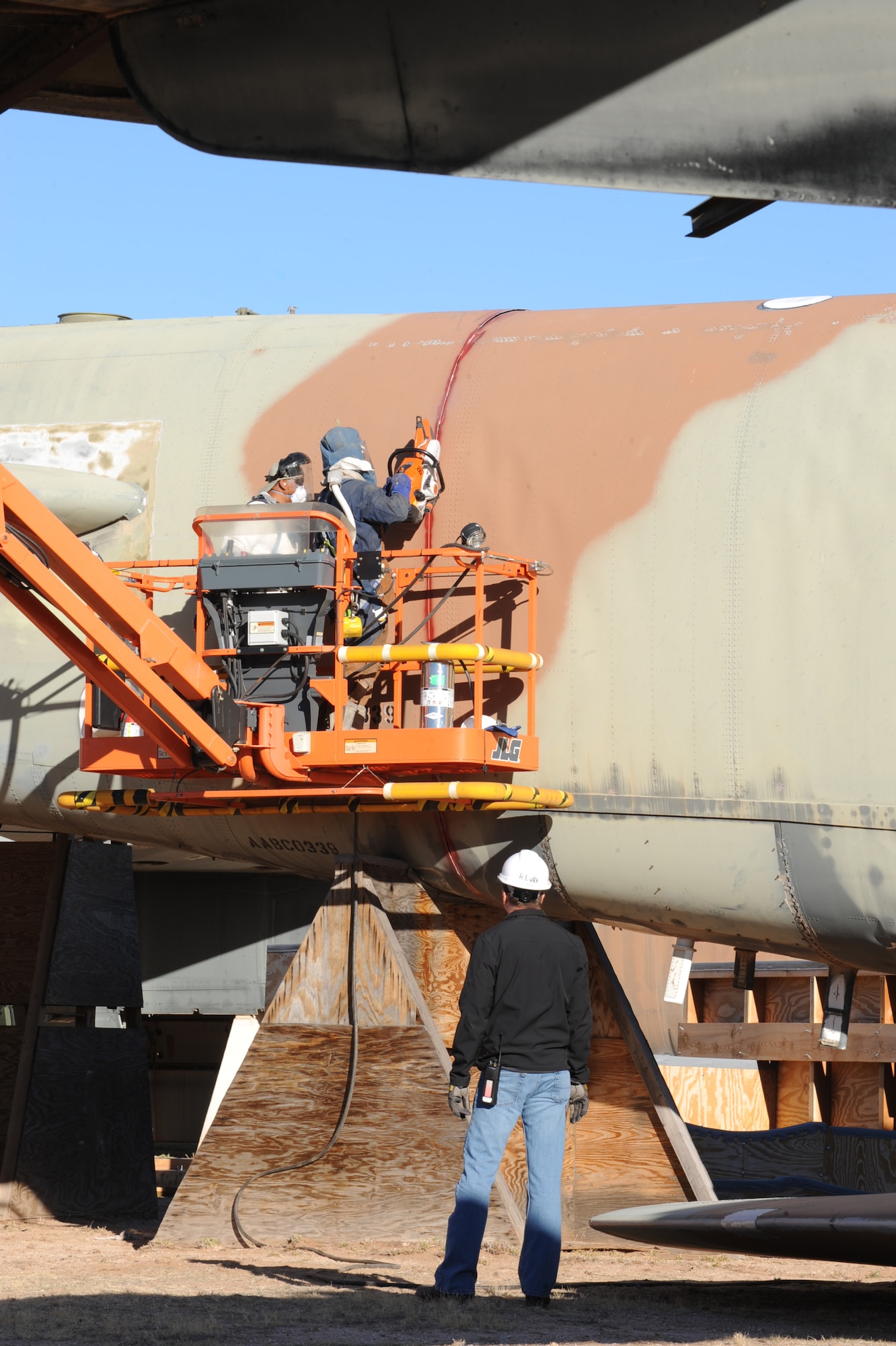 U.S. Air Force employees from the 577th Commodities and Reclamation Squadron cut a B-52G at the 309th Aerospace Maintenance and Regeneration Group, Davis-Monthan Air Force Base, Ariz., Dec. 19, 2013. Under the New START Treaty the aircraft is cut into two pieces separating the tail from the fuselage in order for Russia's sattelites to verify the aircraft's elimination. (U.S Air Force photo by Staff Sgt. Angela Ruiz/released)
