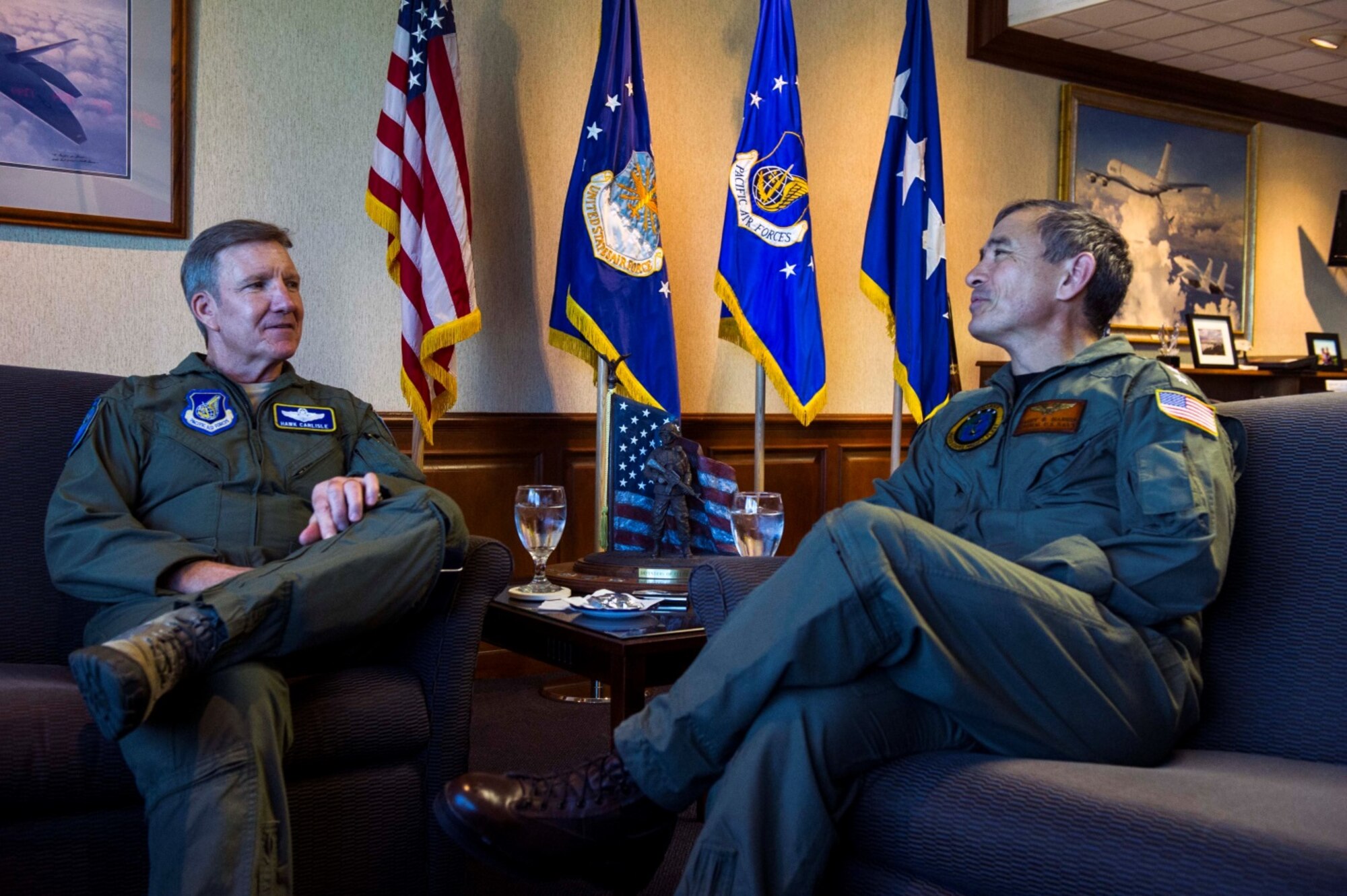 General Hawk Carlisle, Pacific Air Forces commander, speaks with Admiral Harry Harris, U.S. Pacific Fleet commander, in Carlisle's office during Harris's visit to PACAF headquarters for PACAF/PACFLEET staff talks Dec. 17, 2013, at Joint Base Pearl Harbor-Hickam, Hawaii.  More than 75 personnel from PACAF, PACFLEET, and other agencies discussed many issues, including air operations in maritime surface warfare, joint exercise/training opportunities, Pacific resiliency, staff interoperability, and planning integration. (U.S. Air Force photo/Staff Sgt. Nathan Allen)