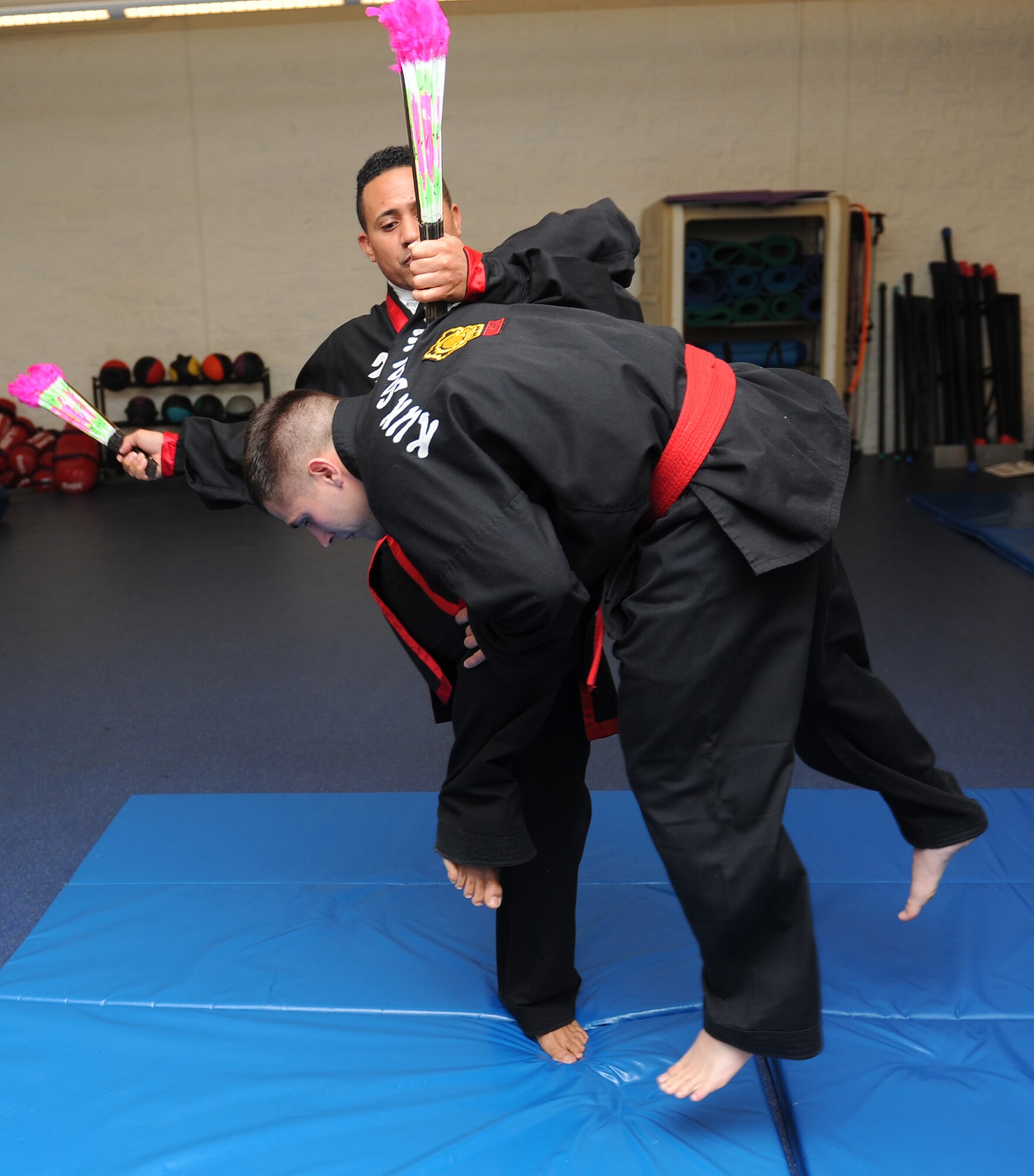 Retired Master Sgt. Amado Garcia, who was previously assigned to the 96th Aircraft Maintenance Squadron Eglin Air Force Base, Fla., launches a student from the floor during a Kuk Sool Won class at the Aderholt Gym on Hurlburt Field, Fla., Dec. 2, 2013. Kuk Sool Won uses more than 20 traditional weapons, meditation, and ki cho ja ki, which is a Korean breathing technique. (U.S. Air Force photo/Senior Airman Kentavist P. Brackin) 