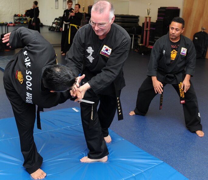 Retired Master Sgt. Amado Garcia, who was previously assigned to the 96th Aircraft Maintenance Squadron, Eglin Air Force Base, Fla., instructs students on knife-disabling techniques during a Kuk Sool Won class at the Aderholt Gym on Hurlburt Field, Fla., Dec. 2, 2013. Garcia is the only authorized Kuk Sool Won instructor in Florida. (U.S. Air Force photo/Senior Airman Kentavist P. Brackin) 