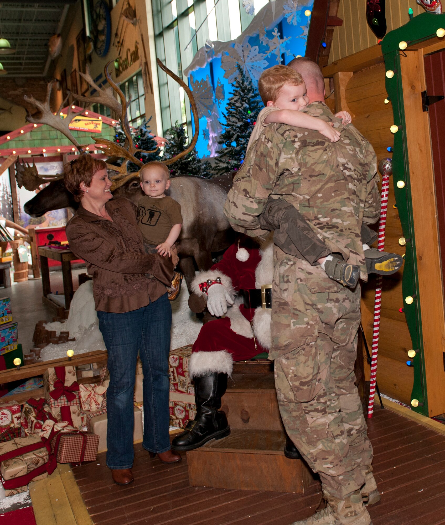 Master Sgt. Jason Slaymaker, 39th Information Operations Squadron operations superintendent, surprises his sons, Jakeb, 4, and Jarret, 2, with an early Christmas present: himself, at the Bass Pro Shop in Destin, Fla., Dec. 20, 2013. Slaymaker spent the last year in Afghanistan. (U.S. Air Force photo/Senior Airman Krystal M. Garrett)