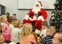PETERSON AIR FORCE BASE, Colo. Dozens of children gathered around Santa Claus Dec. 19 here as he handed out presents. Active duty members of the 52nd Airlift Squadron hosted a Christmas party and potluck for members of the Air Force Reserve Command’s 302nd Airlift Wing and their families. (U.S. Air Force photo/Master Sgt. Daniel Butterfield)