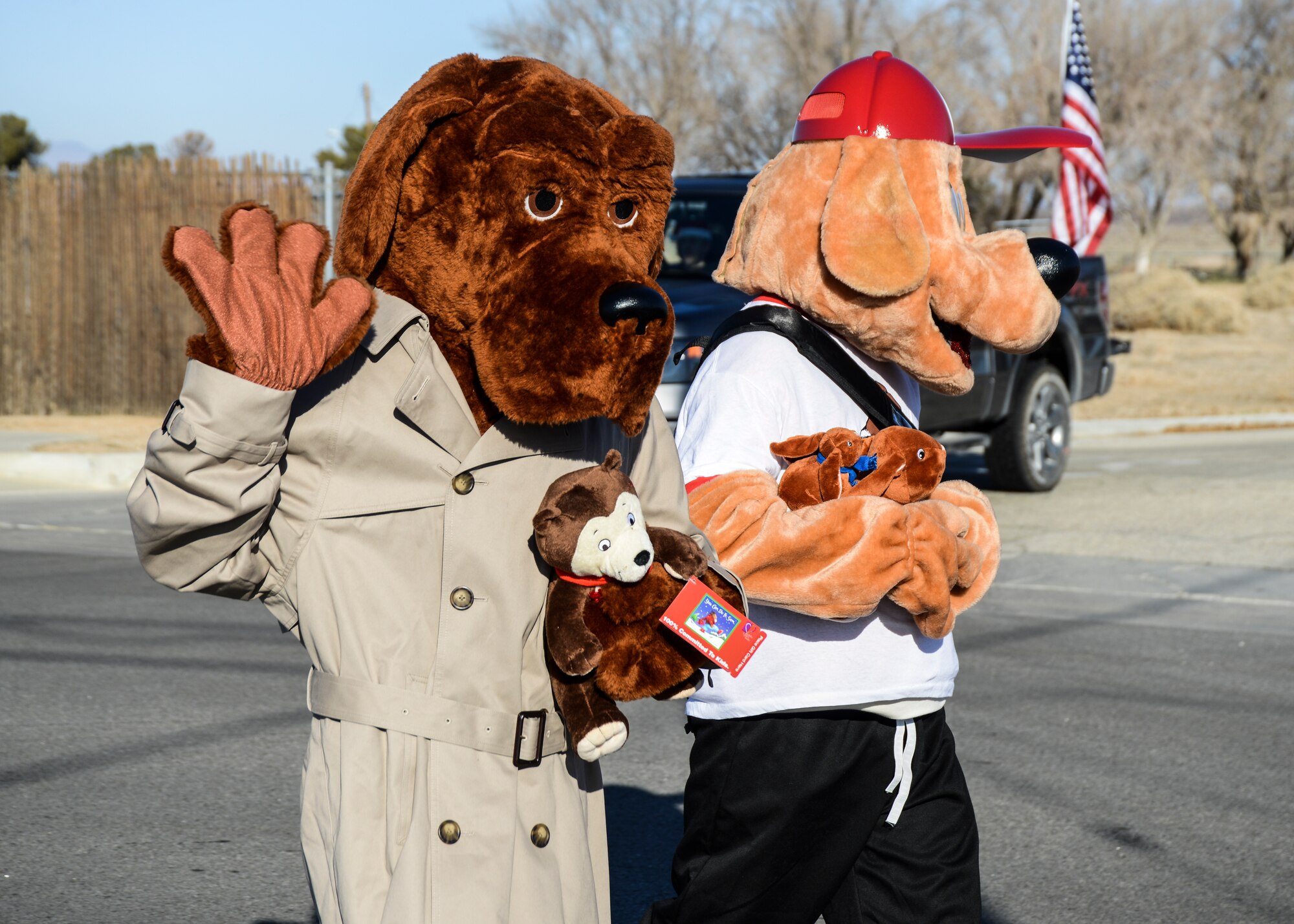 McGruff (left) the Crime Dog and his nephew Scruffy (right) carry their toys down Bailey Avenue. (U.S. Air Force photo by Rebecca Amber)