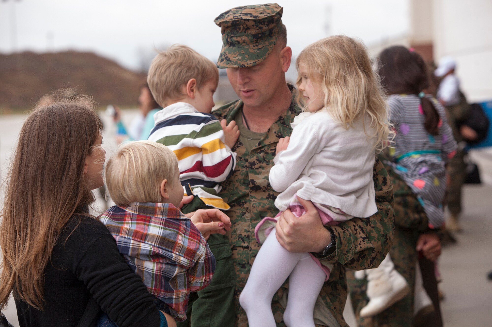 Marine Lt. Col. Robert Muckenthaler, Marine Heavy Helicopter Squadron (HMH) 772 commander, is greeted by his wife and three children after returning from a six-month deployment with his squadron HMH-772 to Marine Corps Air Station Futenma, Japan, as part of the Marine Forces Reserve's participation in the Unit Deployment Program Dec. 5, 2013, on Joint Base McGuire-Dix-Lakehurst, N.J. “The mission for us was to re-establish the unit deployment program for the Marine Corps rotary squadron,” said Muckenthaler, a West Bridgewater, Mass., native. (U.S. Air Force photo by Wayne Russell/Released)