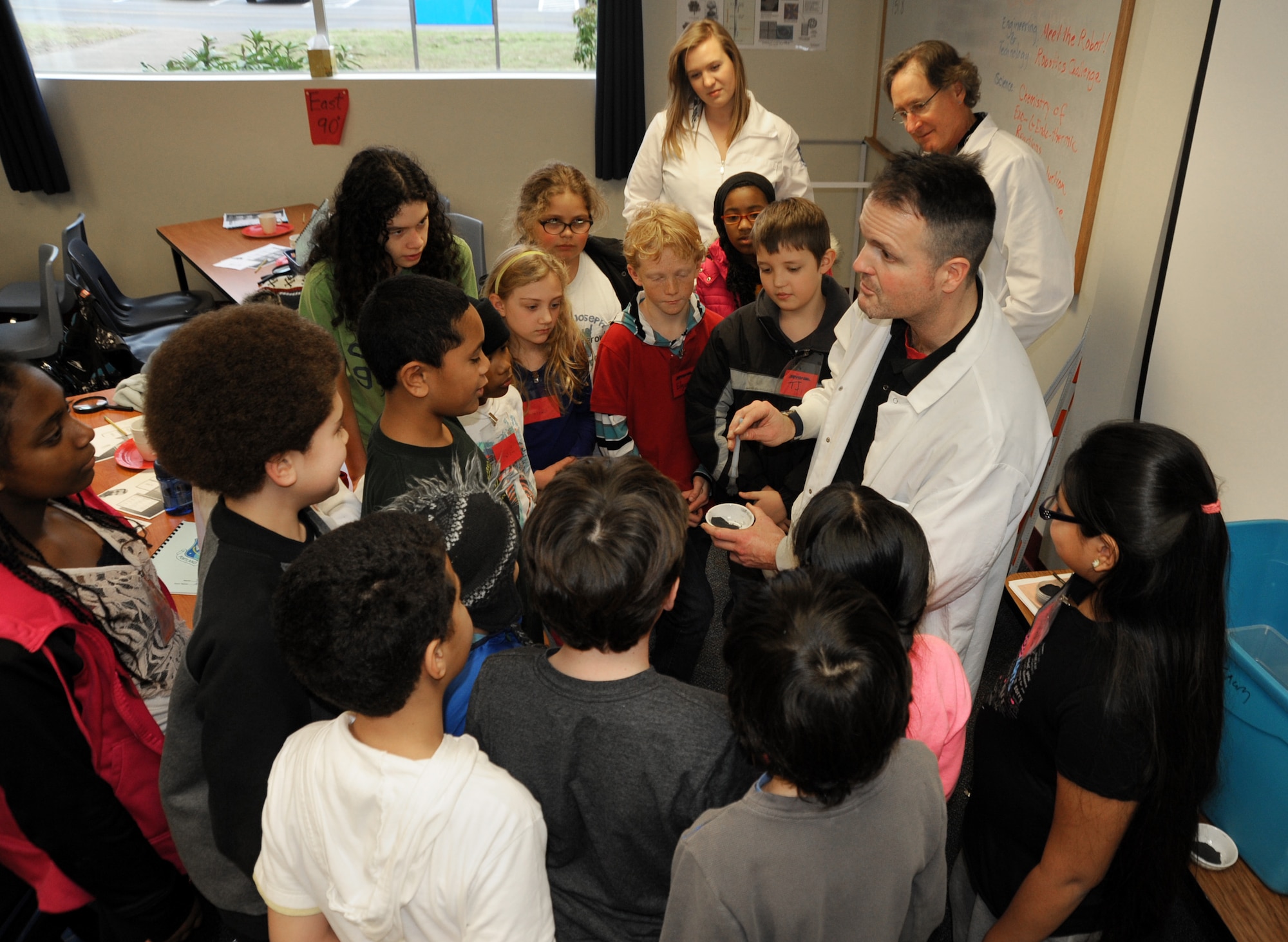Jon Dyer, a State of Oregon Forensic Scientist, gives detailed instructions on a finger print experiment to a student group from Chief Joseph-Ockley Green Elementary School in Portland, Ore., Dec. 16, 2013. STARBASE Academies help teach more than 75,000 students nationally each year in math and science education. (Air National Guard photo by Tech. Sgt. John Hughel, 142nd Fighter Wing Public Affairs/Released)