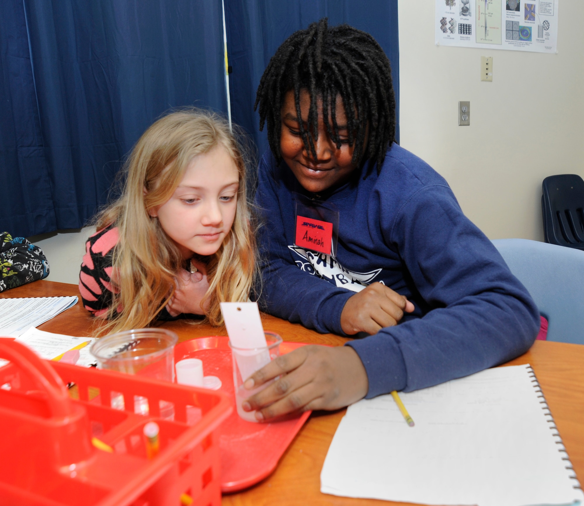 Students from Chief Joseph-Ockley Green Elementary School in Portland, Ore., conduct an experiment to create hot and cold chemical reactions while attending the STARBASE educational program held at the Portland Air National Guard Base, Ore., Dec. 9, 2013. STARBASE Academies help teach more than 75,000 students nationally each year in math and science education. (Air National Guard photo by Tech. Sgt. John Hughel, 142nd Fighter Wing Public Affairs/Released)