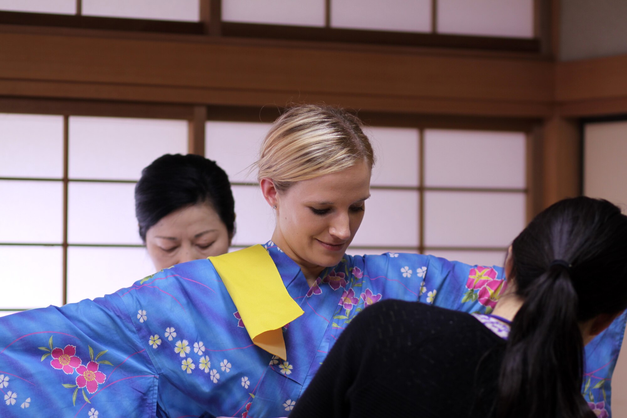 Capt. Rachel Ianacone, 62nd Operations Support Squadron airfield operations officer and 62nd Airlift Wing executive officer, is assisted with putting on a kimono in Fukuoka, Japan, May 7, 2013. She had to wear the kimono as part of a tea ceremony cultural class while participating in a Language Enabled Airmen Program immersion. (Courtesy photo)