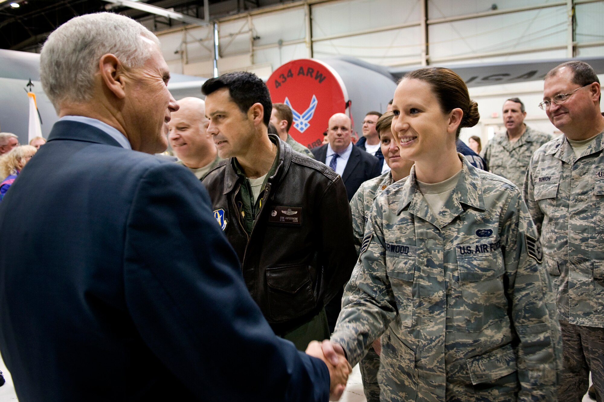 Staff Sgt. Erica Sherwood, 434th Force Support Squadron personnel specialist, shakes hands with Indiana Gov. Mike Pence at Grissom Air Reserve Base, Ind., Dec. 19, 2013. During Pence's visit to the Hoosier base, he  shook hands with nearly every one of the approximately 100 Grissom employees in attendance before taking part in a tour of a 434th Air Refueling Wing KC-135. (U.S. Air Force photo/Tech. Sgt. Mark R. W. Orders-Woempner)
