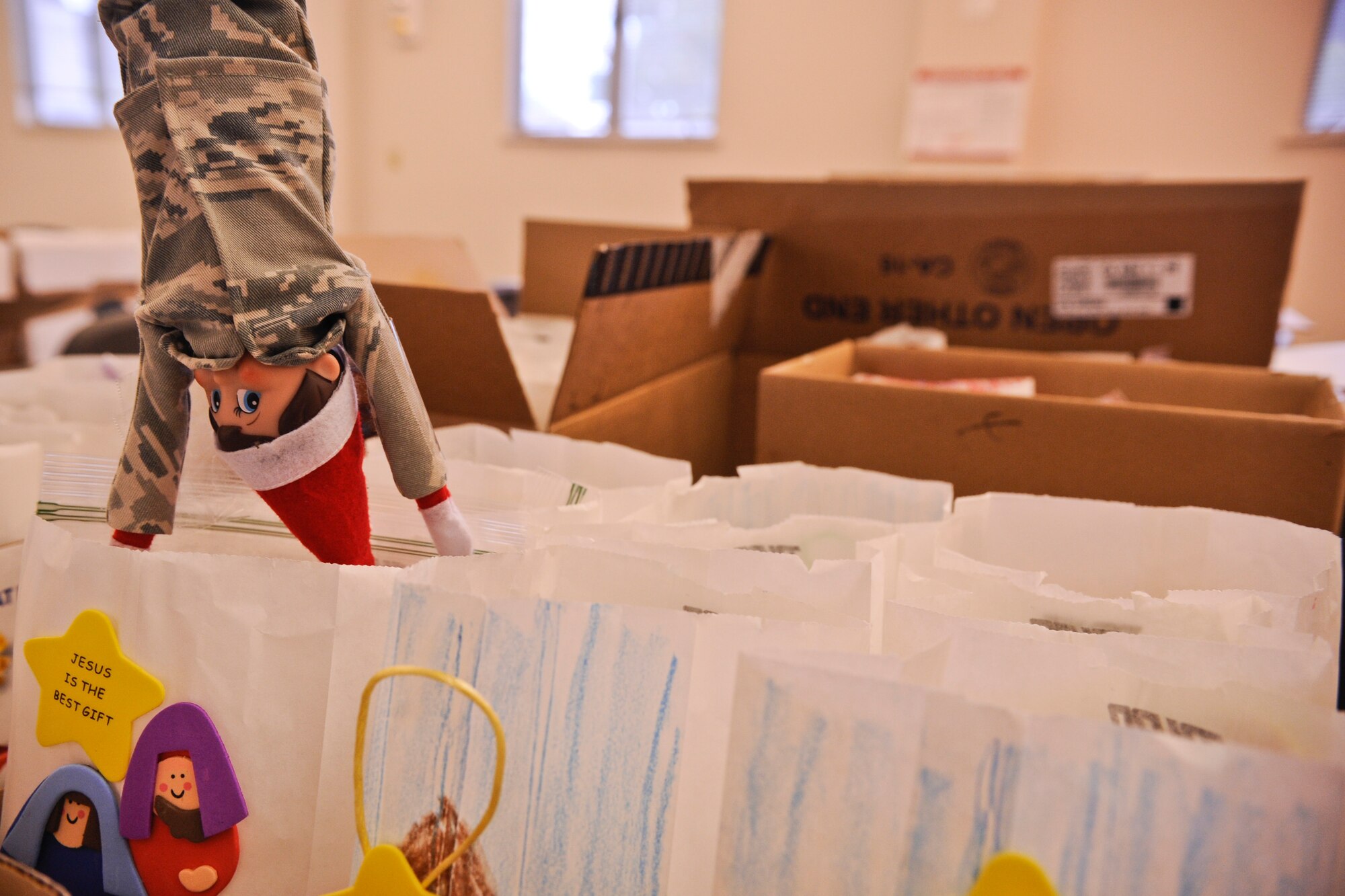 VANDENBERG AIR FORCE BASE, Calif. – Airman Elf dives into a bag of donated cookies here Dec. 20, 2013. Cookies baked by spouses and military members around base were put into bags decorated by Crestview and homeschooled children. The Holiday Cookie Express has been giving Airmen warm smiles and cookies during the holidays for the over 12 years. (U.S. Air Force photo/ Airman 1st Class Yvonne Morales)