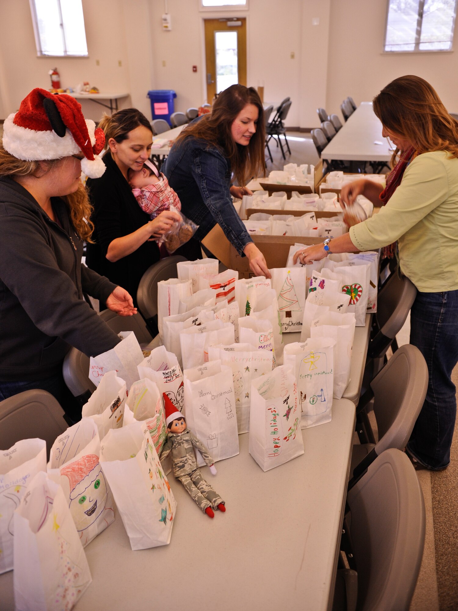 VANDENBERG AIR FORCE BASE, Calif. – Members of the Vandenberg Spouses Club put together bags of donated cookies here Dec. 20, 2013. Cookies baked by spouses and military members around base were put into bags decorated by Crestview and homeschooled children. The Holiday Cookie Express, which started more than 12 years ago, gives Airmen warm smiles and cookies during the holiday season. (U.S. Air Force photo/ Airman 1st Class Yvonne Morales)