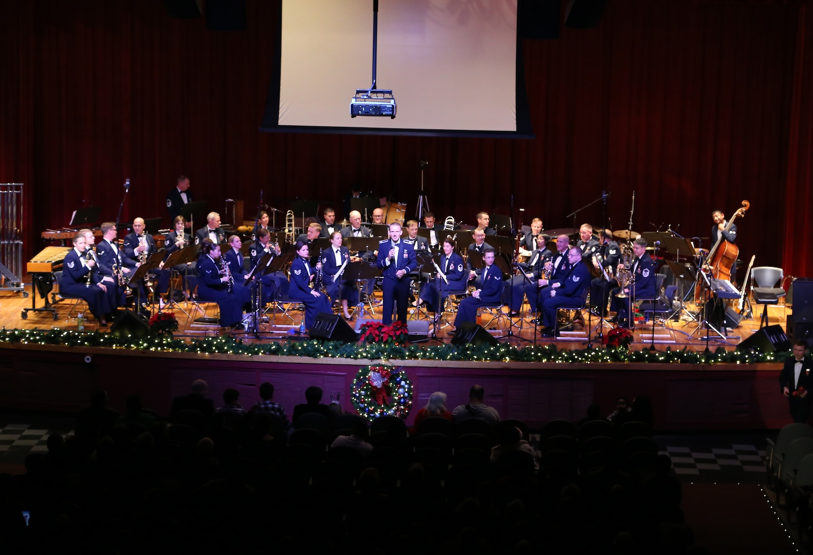 Air Force Capt. Joseph Hansen, Air Force Band of the West deputy commander and conductor, explains the story behind the pieces performed Dec. 17 at the Joint Base San Antonio-Lackland Bob Hope Theater. (U.S. Air Force photo by Airman 1st Class Lincoln Korver)