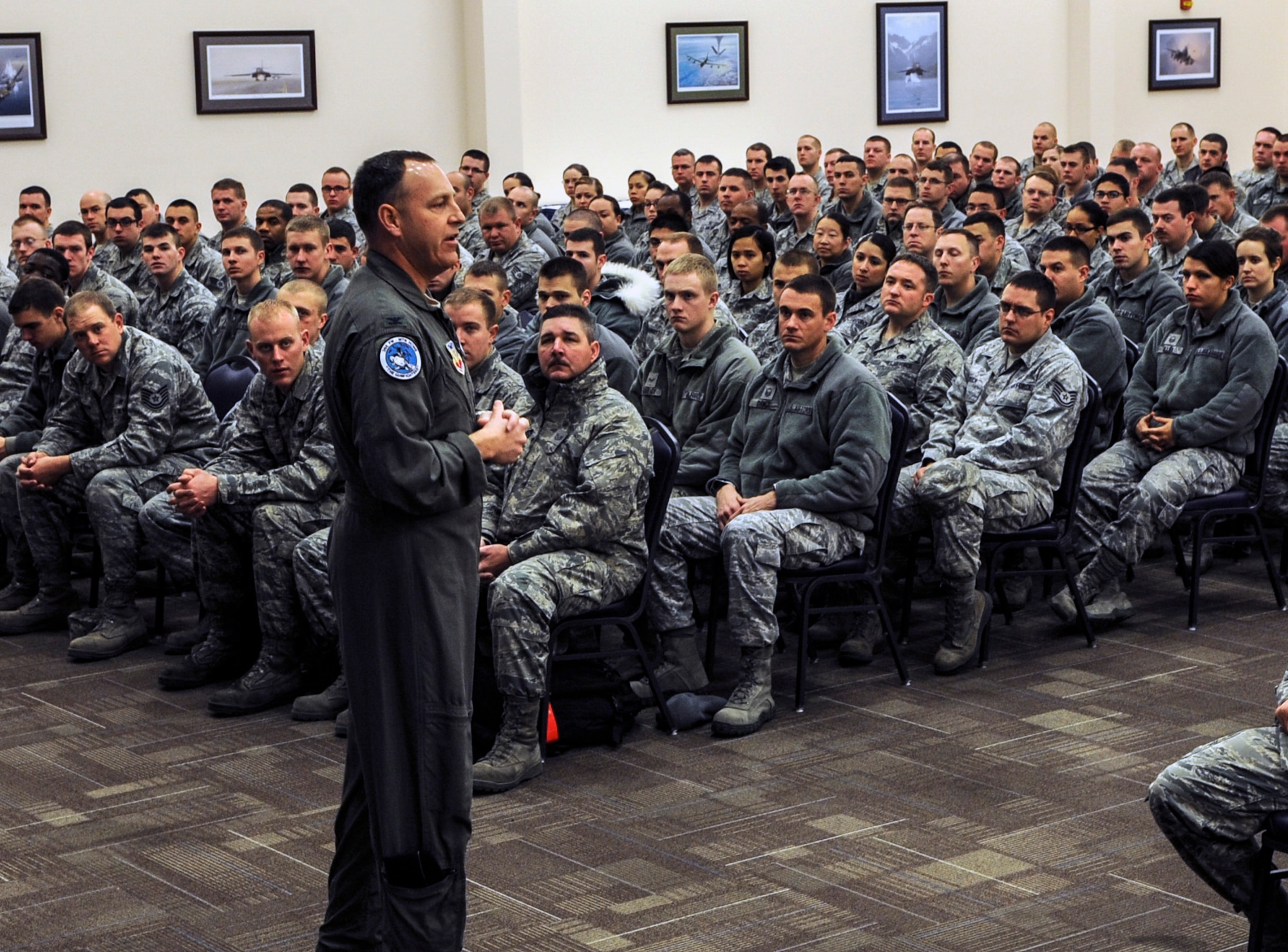Air Force Col. Christopher Short, 366th Fighter Wing commander, gatherers officer and enlisted Gunfighters during six force management town hall meetings at Mountain Home Air Force Base, Idaho, Dec. 20 and 23, 2013. Short told Airmen that as the force becomes smaller, its important to retain high performing Airmen, so job performance is and will continue to be his first priority. (U.S. Air Force photo by Master Sgt. Kevin Wallace/RELEASED)