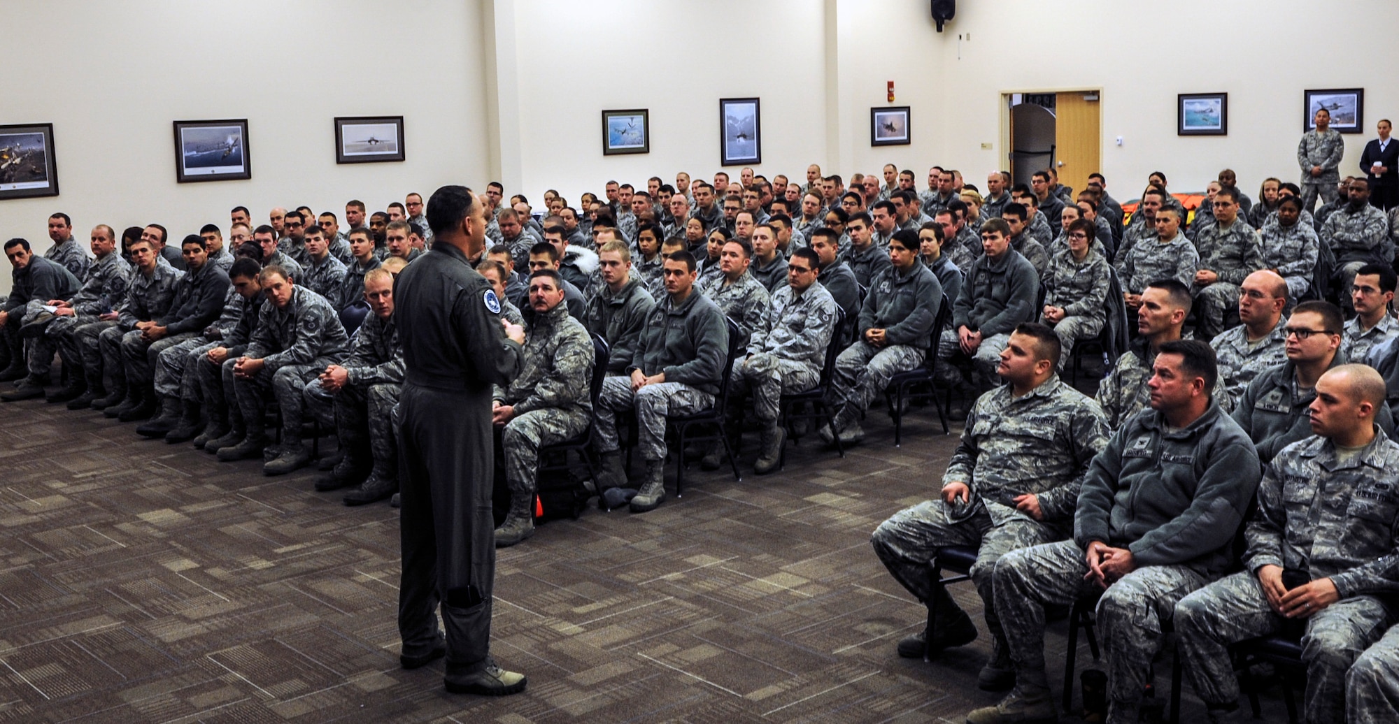 Air Force Col. Christopher Short, 366th Fighter Wing commander, addresses enlisted Airmen during a force management town hall meeting at Mountain Home Air Force Base, Idaho, Dec. 20, 2013. Budget constraints have led to reductions in Air Force readiness and force shape initiatives have begun to size and shape the Air Force. (U.S. Air Force photo by Master Sgt. Kevin Wallace/RELEASED)