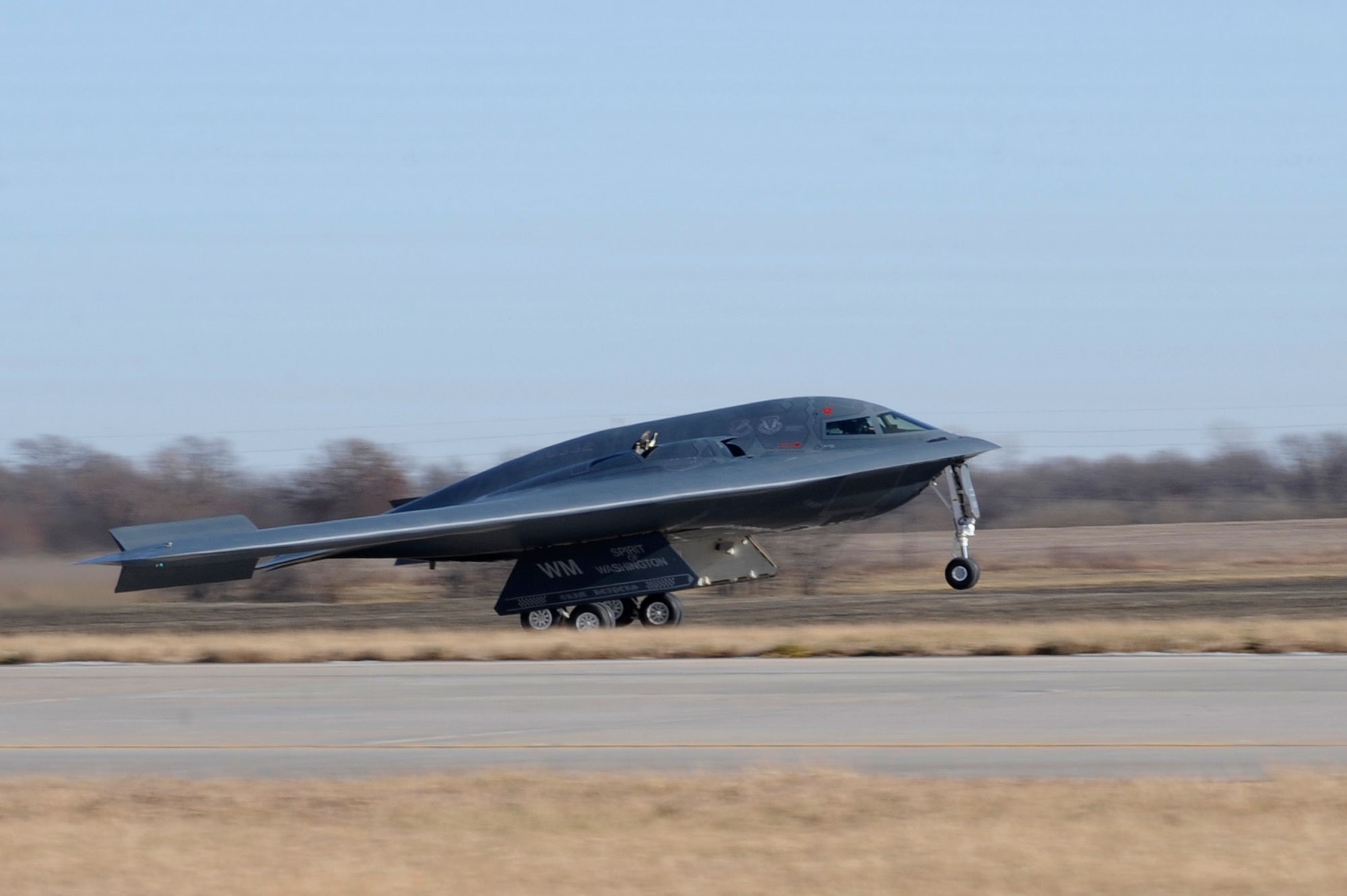 The “Spirit of Washington” lands at Whiteman Air Force Base, Mo., Dec. 16, 2013. The B-2 Spirit participated in its first training mission here after an engine fire in 2010 badly damaged the aircraft. The “Spirit of Washington” was preparing to fly a mission at Anderson Air Force Base, Guam, when one of its four engines caught fire. After nearly four years, the aircraft was restored to full mission-ready status.  (U.S. Air Force photo by Staff Sgt. Alexandra M. Boutte/Released)